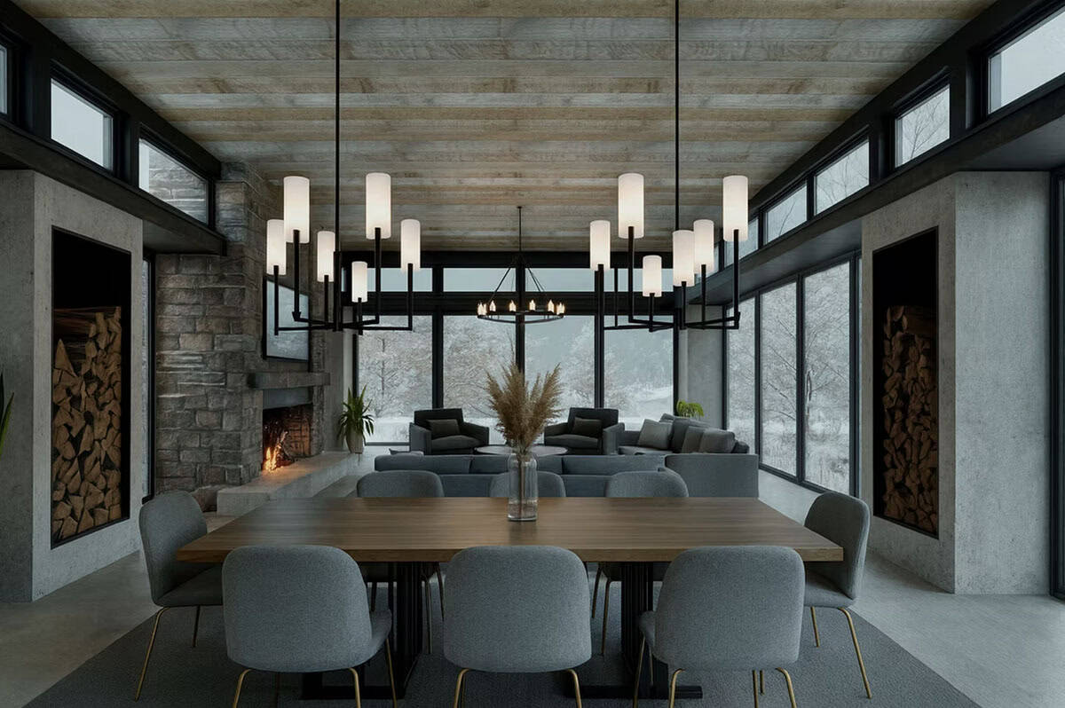 Open plan dining room with stone fireplace, wood storage niches, cylinder pendant lights, and winter snow views in Hudson Wisconsin contemporary home