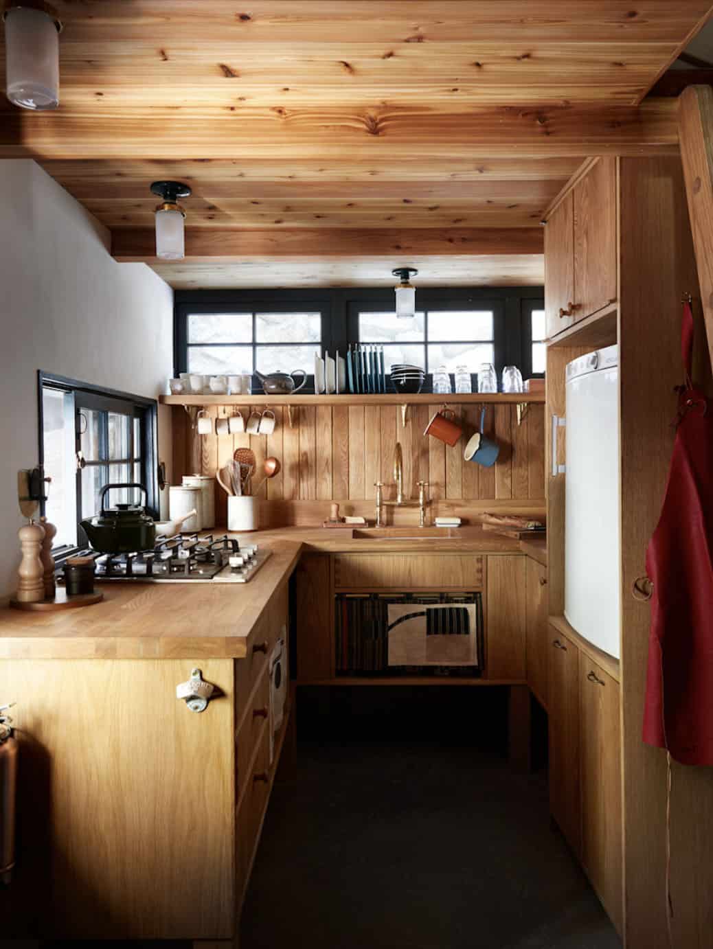 Compact kitchen with custom oak cabinetry, butcher block countertops, and open shelving, San Gabriel Mountains cabin