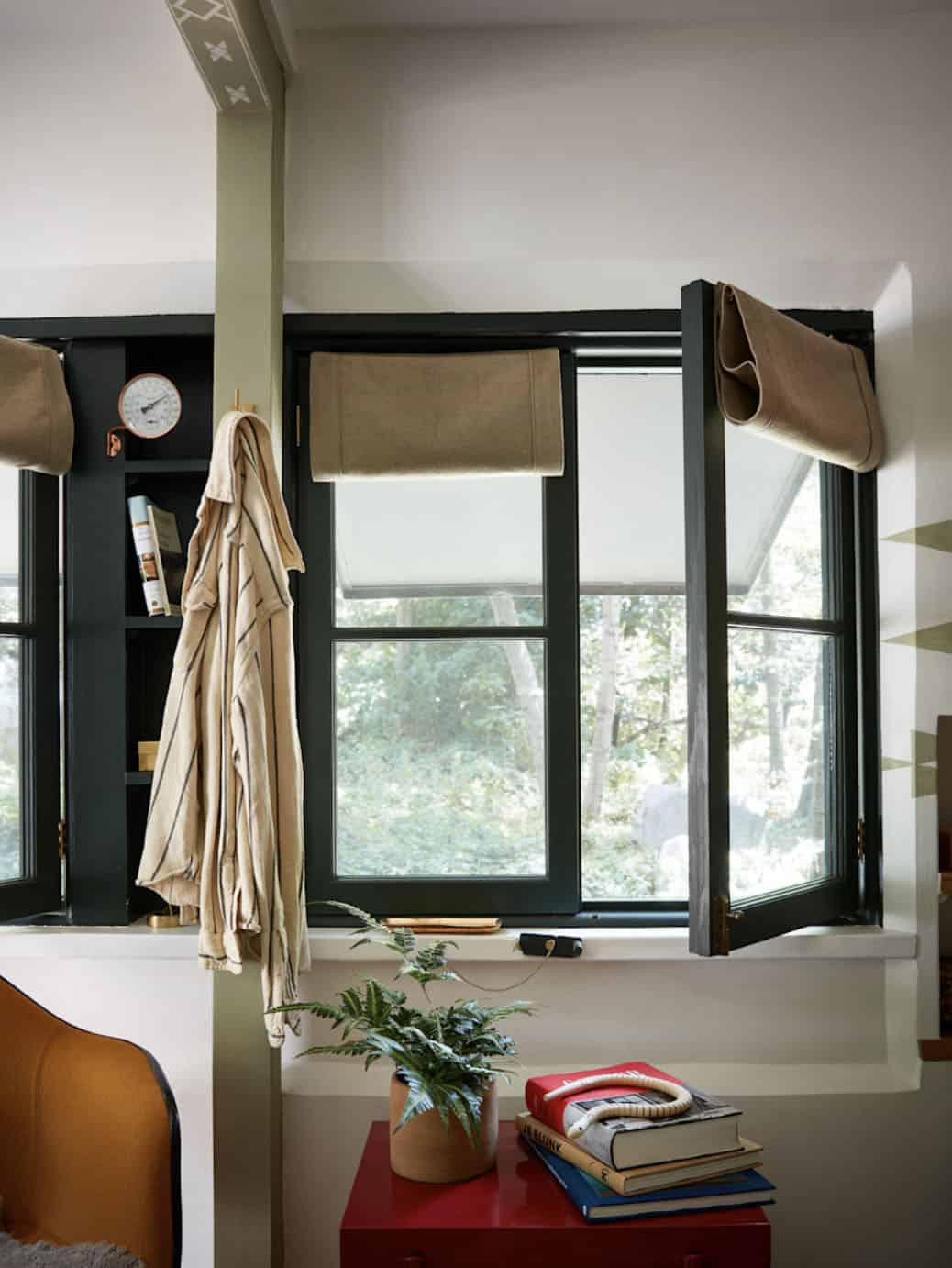 Bunk room window with linen roman shades and hand-painted geometric wall pattern