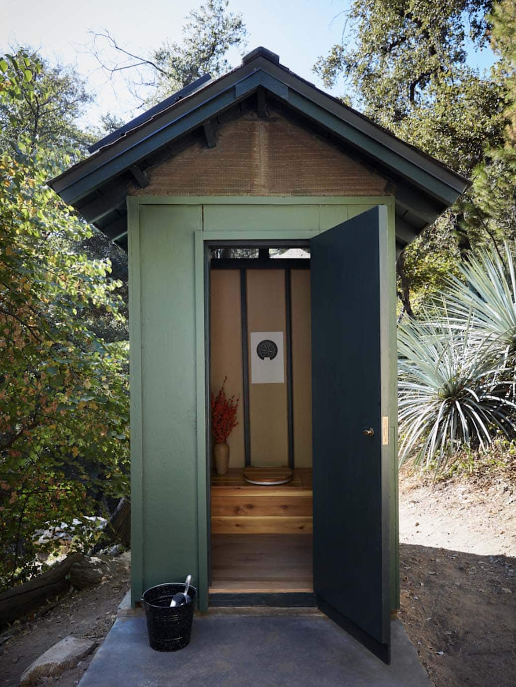 Green painted outhouse with bamboo ceiling and native yucca plants, San Gabriel Mountains, California