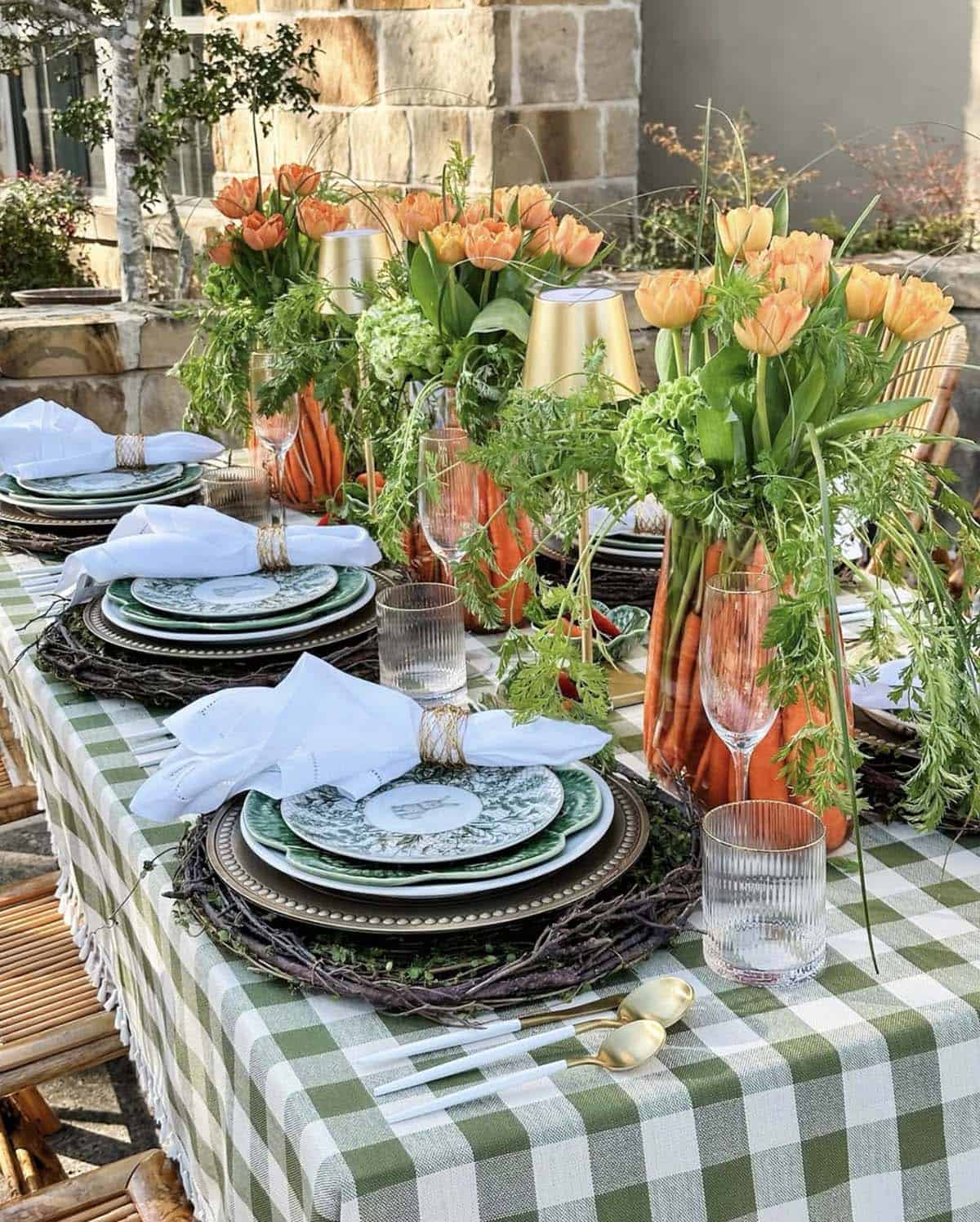 Farm-fresh Easter table decorating idea with carrots, orange tulips, and cabbage plates