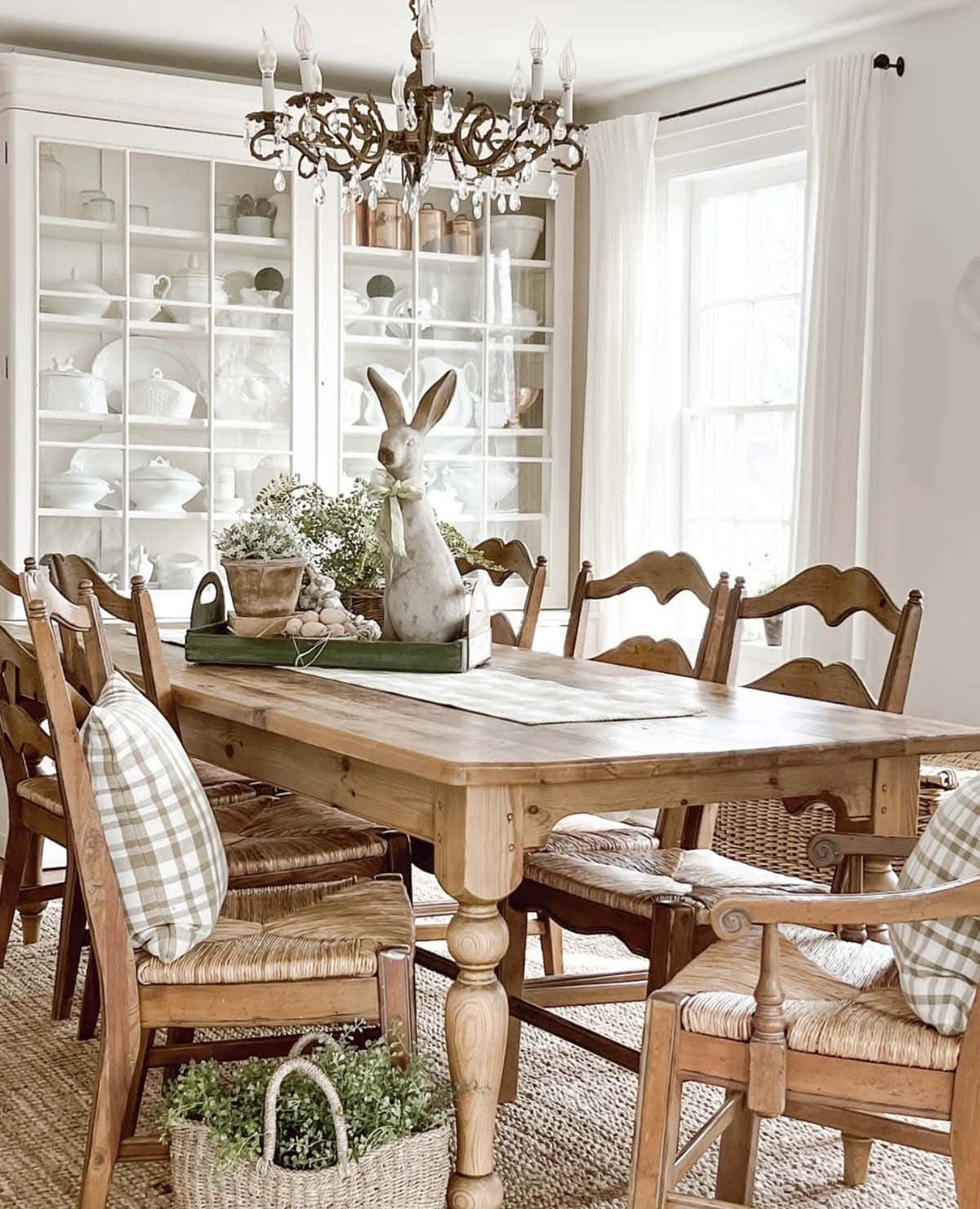 easter decorated dining table with a wood tray and large bunny centerpiece