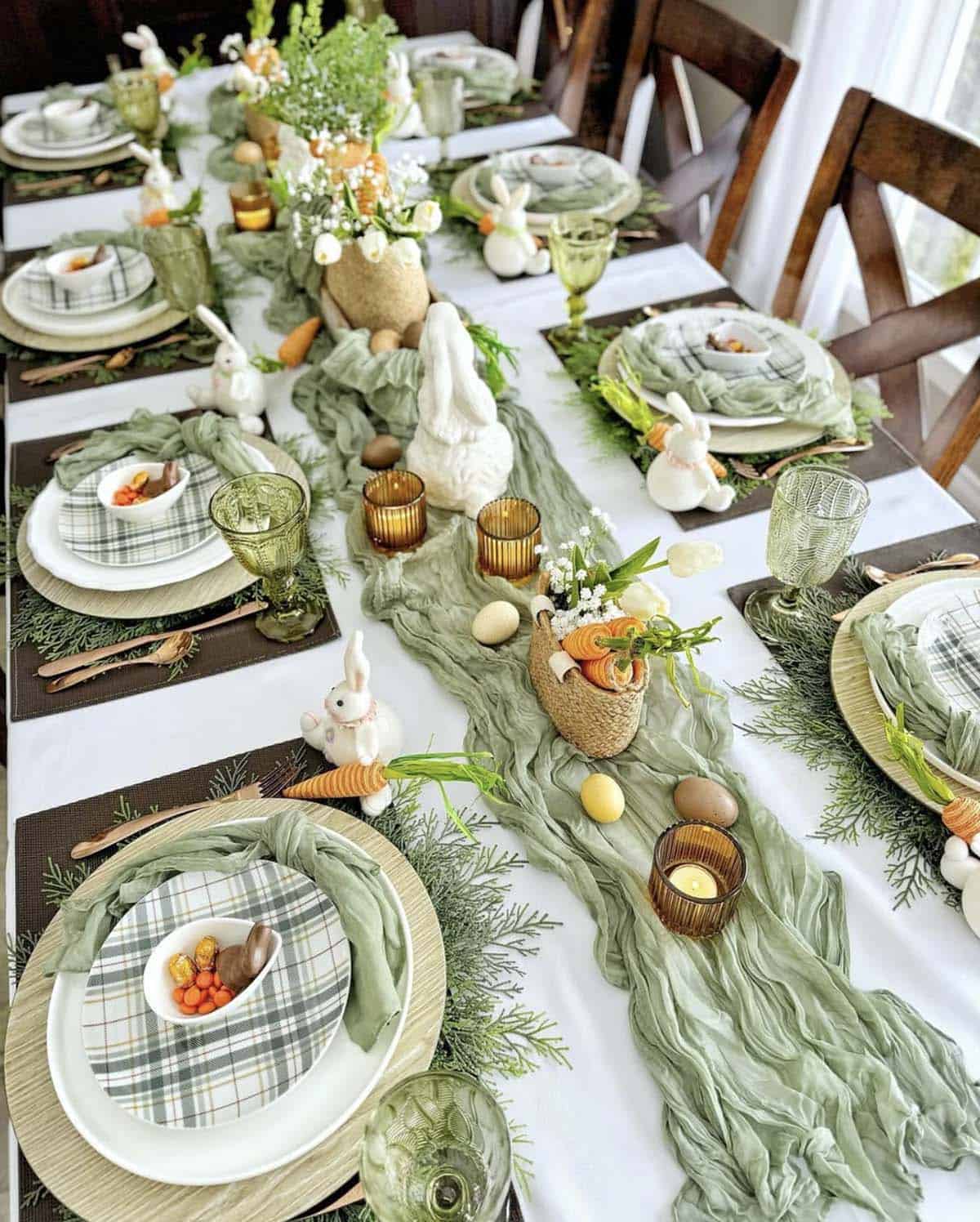 Easter tablescape with sage green cheesecloth runner, faux cedar placemats, and white ceramic bunny figurines