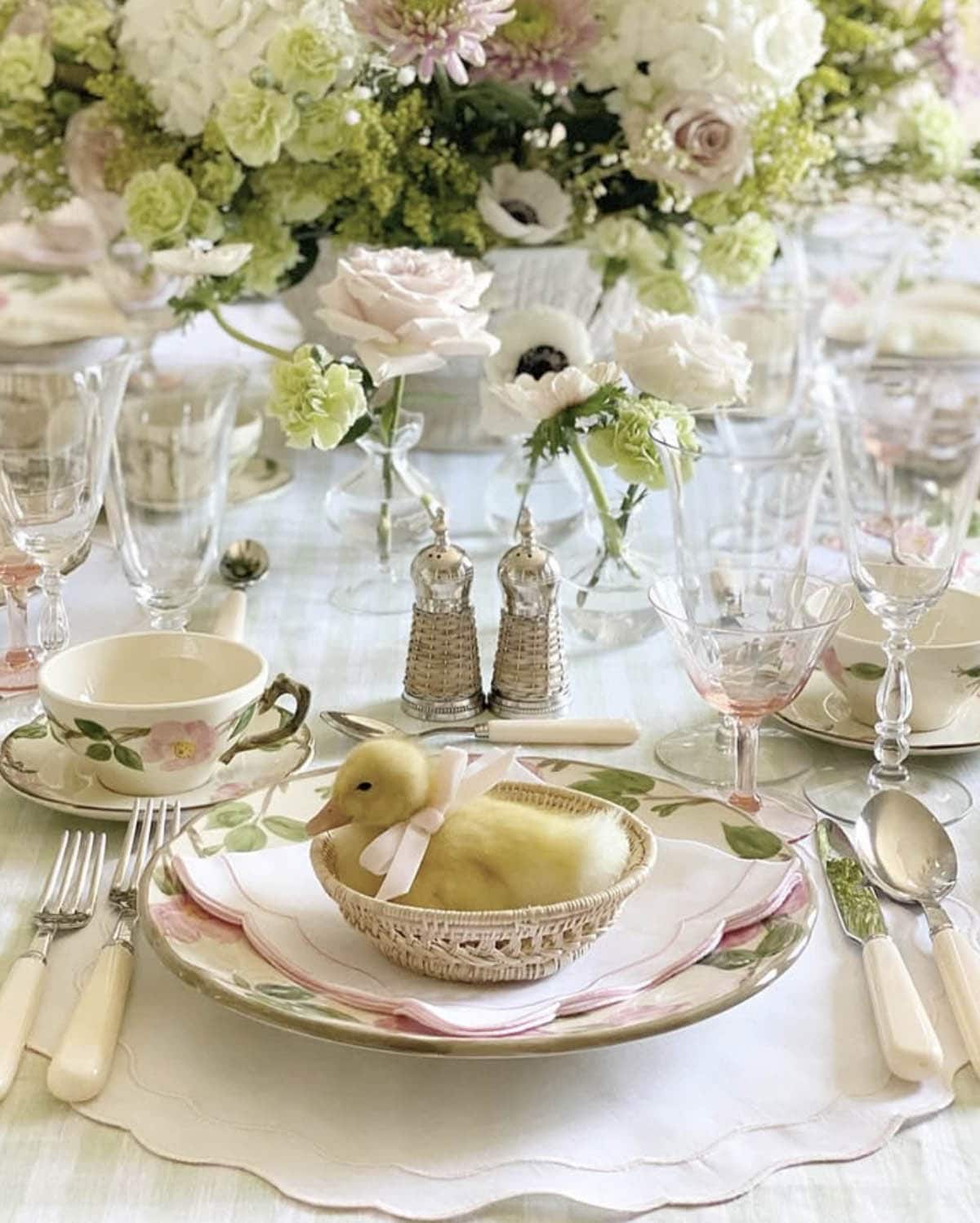 Easter place setting with baby duckling, family heirloom china, and English garden floral centerpiece