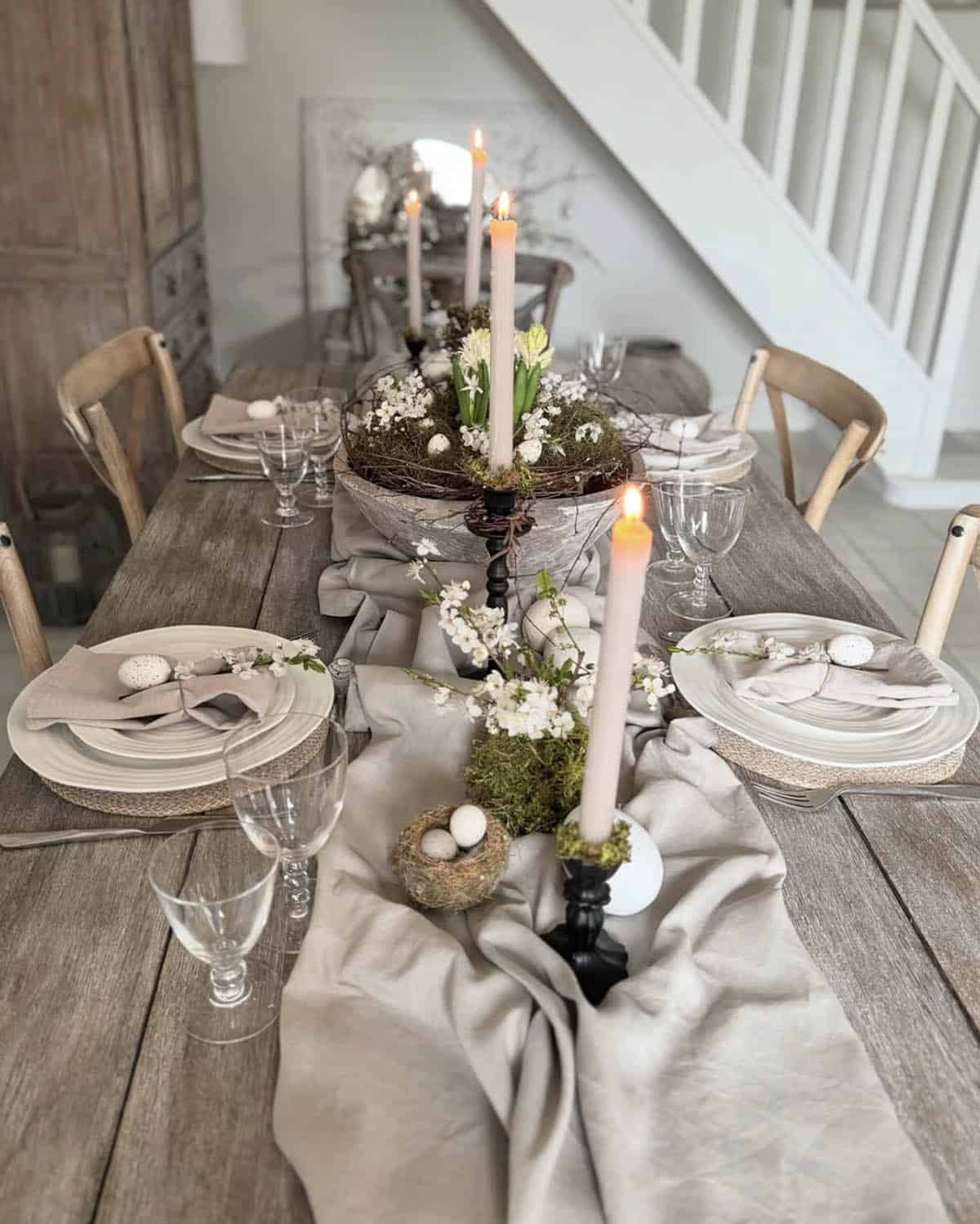 Neutral Easter table with linen runner, dough bowl centerpiece, hyacinths, and bird's nest accents