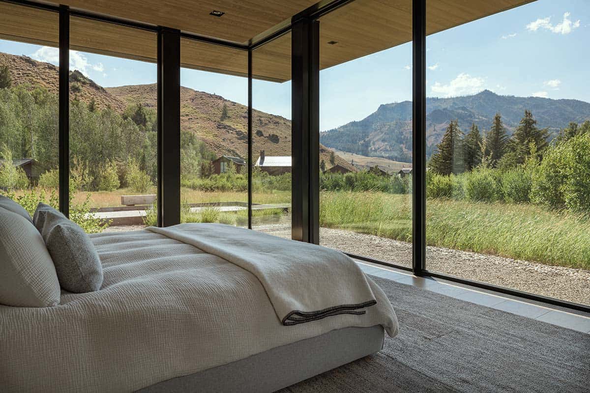 Bedroom with wraparound corner windows framing panoramic Idaho mountain views