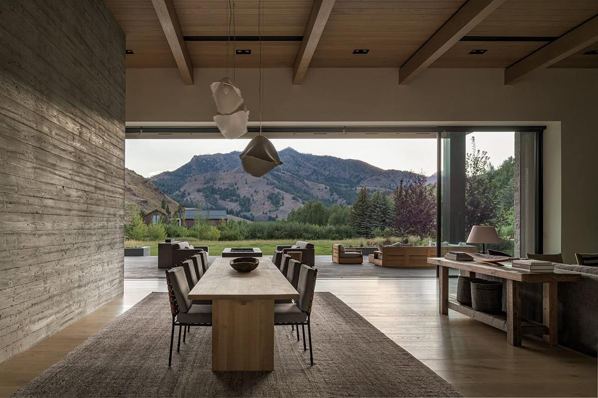 Dining room with oak beam ceiling opening to terrace and unobstructed Idaho mountain views