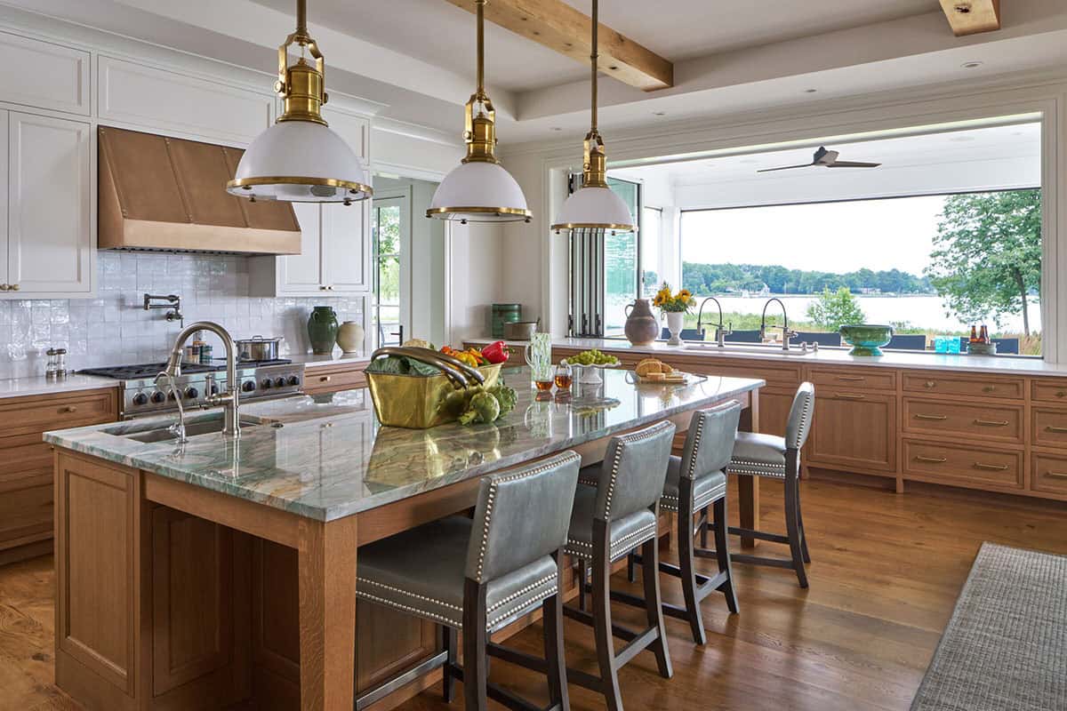 White kitchen with white oak cabinets and range hood in Maryland Eastern Shore waterfront home