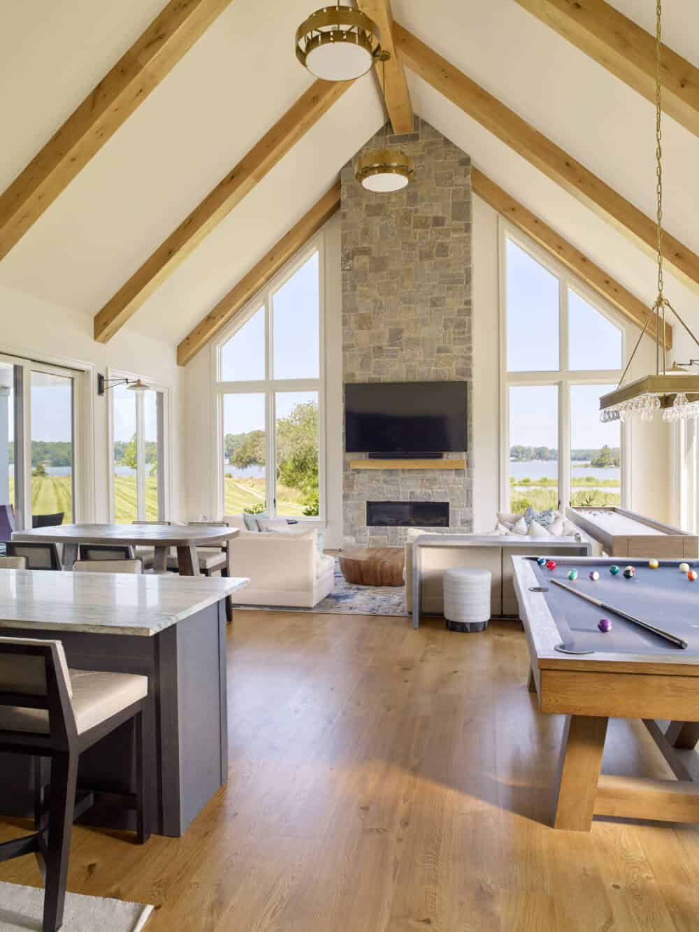 Elegant transitional great room with white oak floors and water views in Maryland farmhouse
