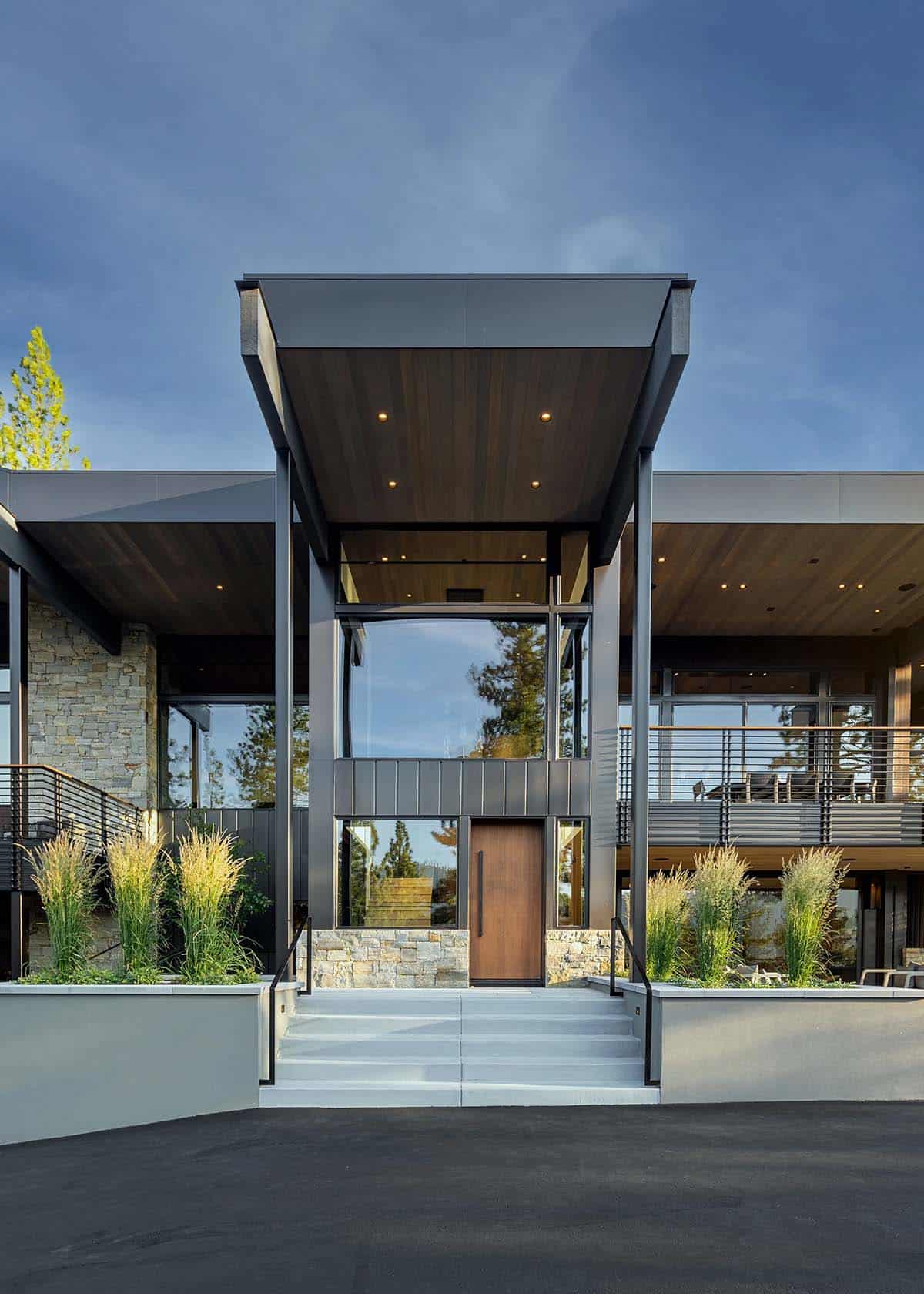 Dramatic front entrance with cantilevered steel canopy and wood pivot door
