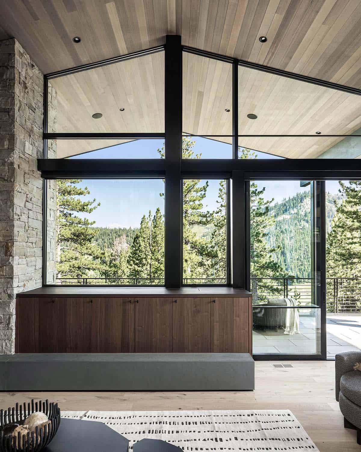 Vaulted interior with floor-to-ceiling glass and walnut built-in cabinetry