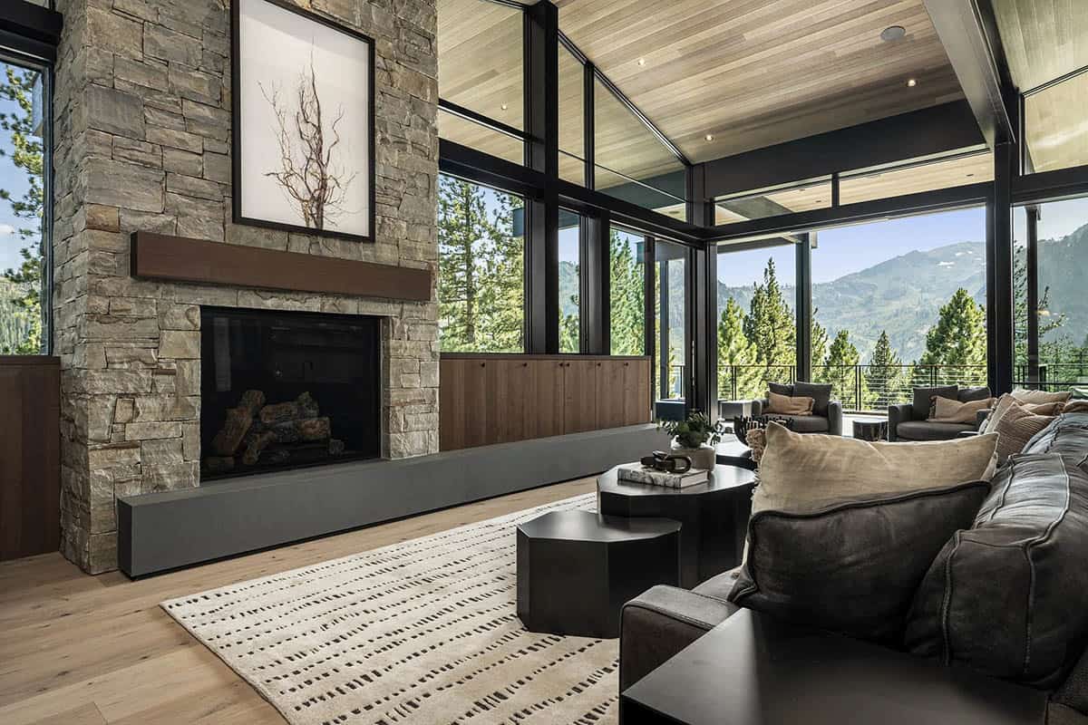 Great room with stacked stone fireplace and panoramic mountain views