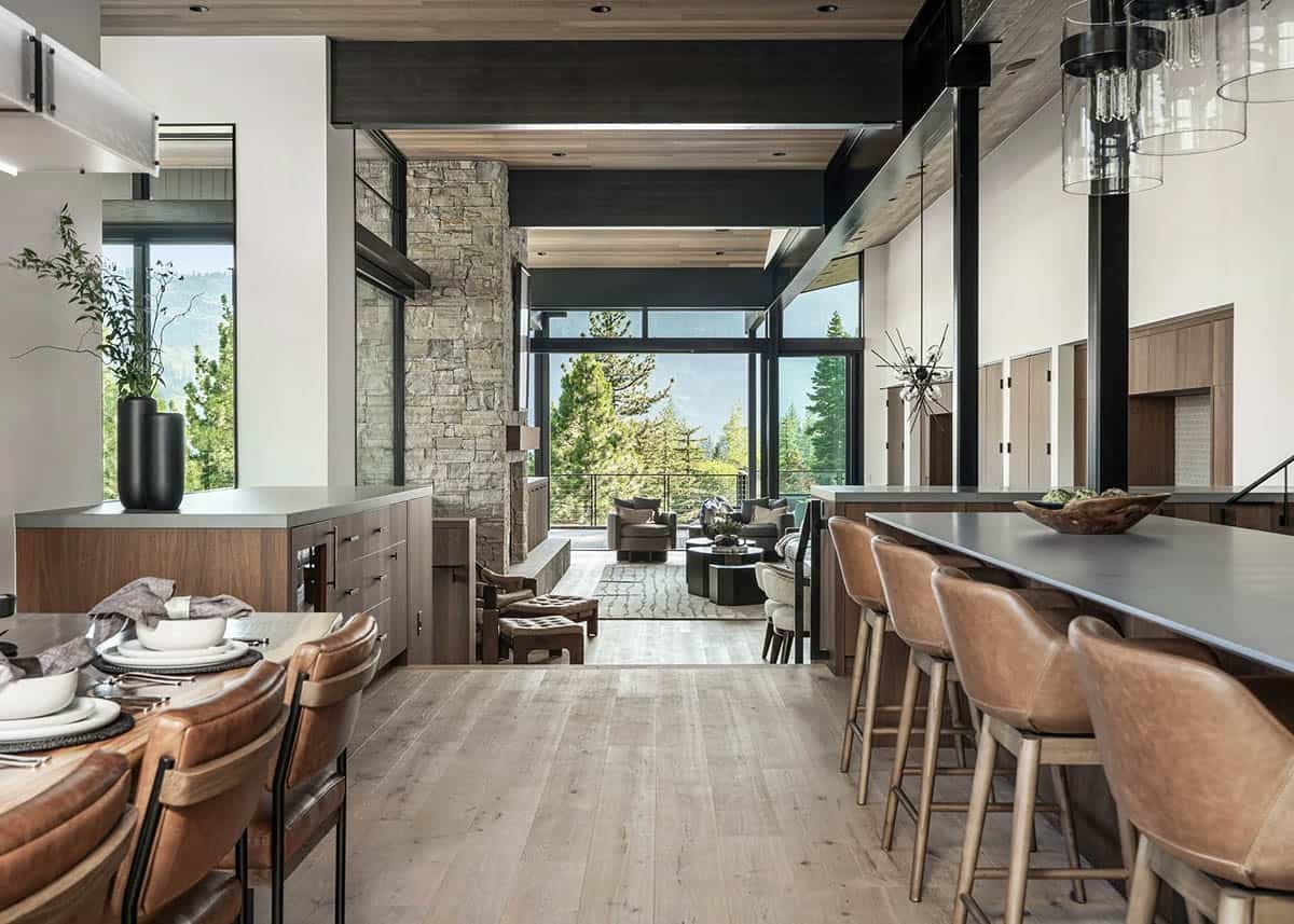 Open-plan kitchen and dining area flowing into living room with mountain views beyond