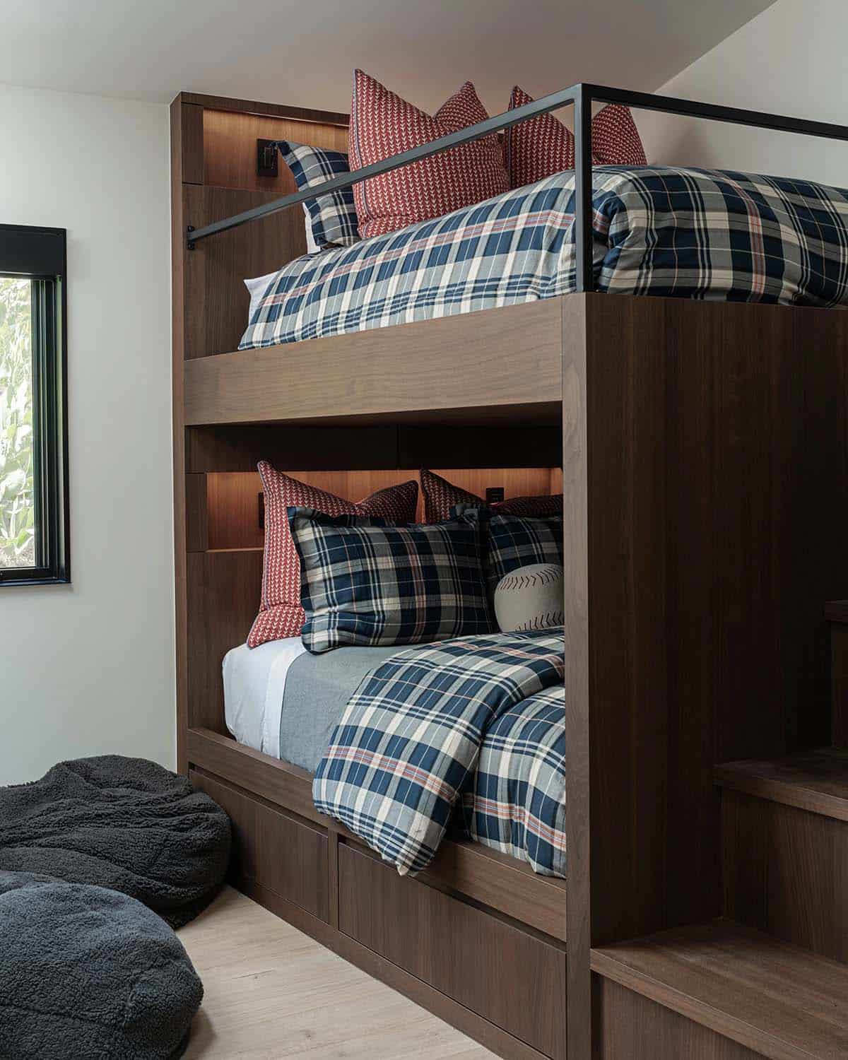 Built-in walnut bunk beds with plaid bedding and under-bed storage drawers