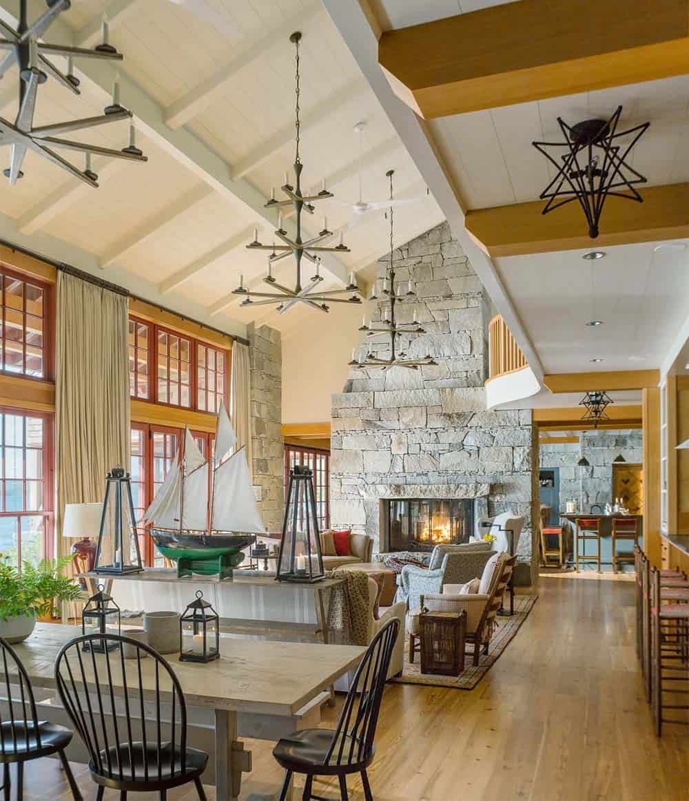 Dining area of the Lake Sunapee New Hampshire lake house with natural light streaming through multi-paned windows, a large farmhouse-style dining table, and casual seating suited to extended family gatherings