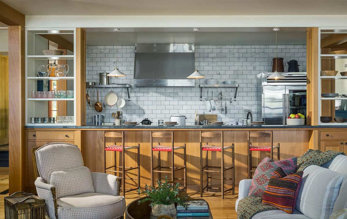 Traditional lake house kitchen with painted shaker cabinetry, soapstone or natural stone countertops, a farmhouse sink, and a window overlooking the Lake Sunapee shoreline, New Hampshire