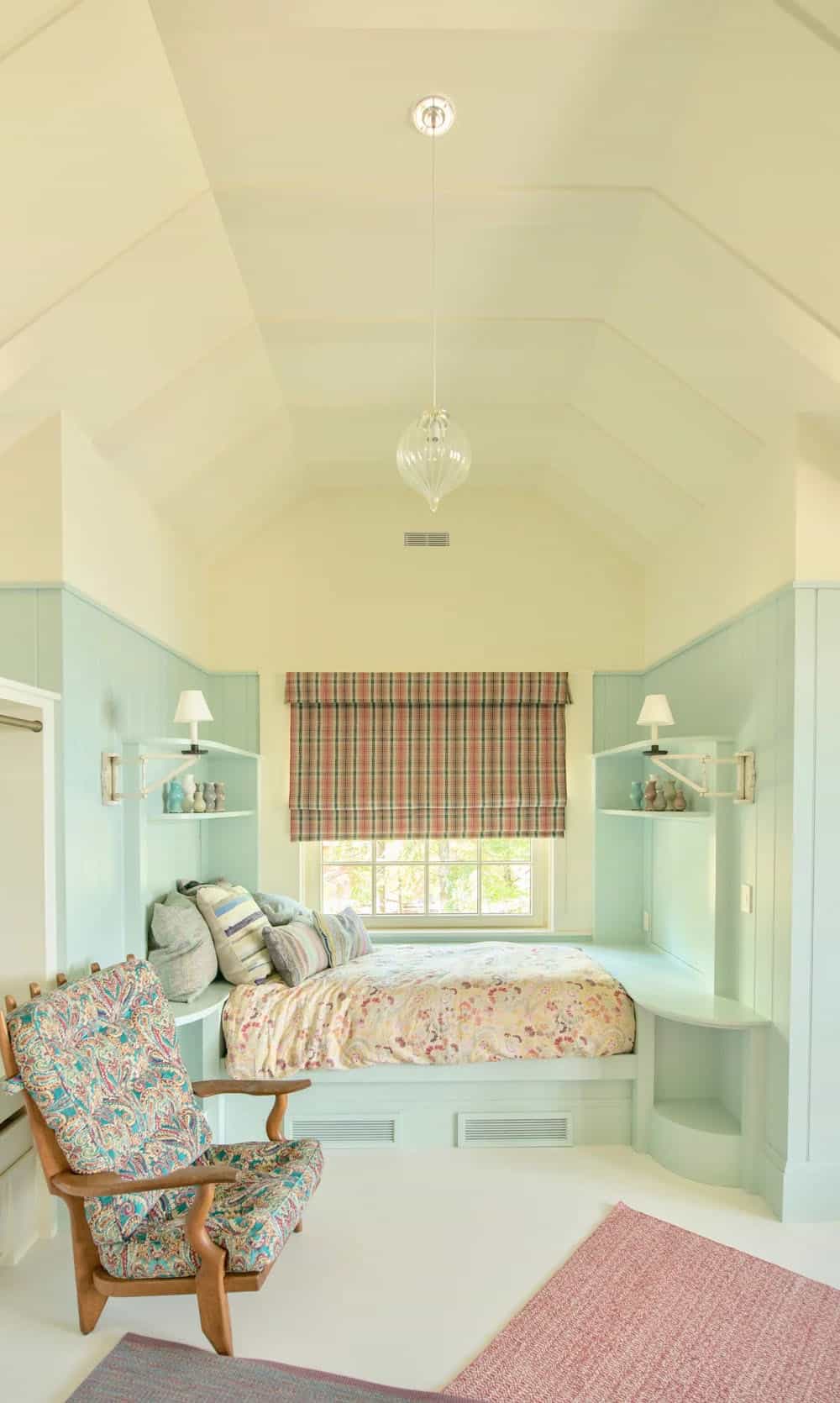 Upstairs bedroom in the New Hampshire lake house with traditional furnishings, a painted wood ceiling, and a window overlooking the lake or the surrounding meadow landscape