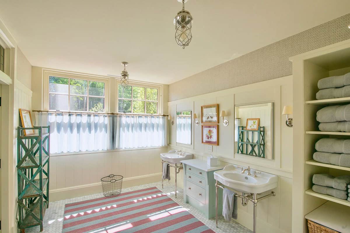 Bathroom with traditional finishes in the Lake Sunapee New Hampshire lake house &mdash; white subway tile, a painted wood vanity with stone countertop, and classic black or chrome fixtures