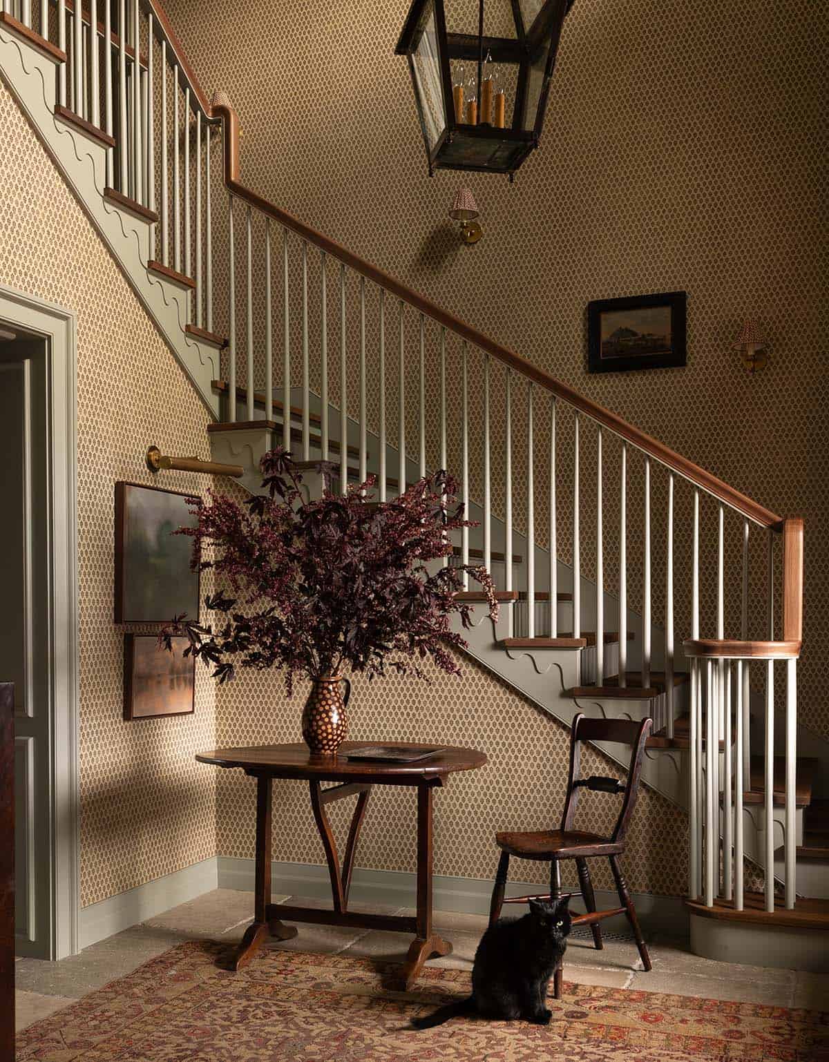 contemporary staircase with a small table and a vase of flowers