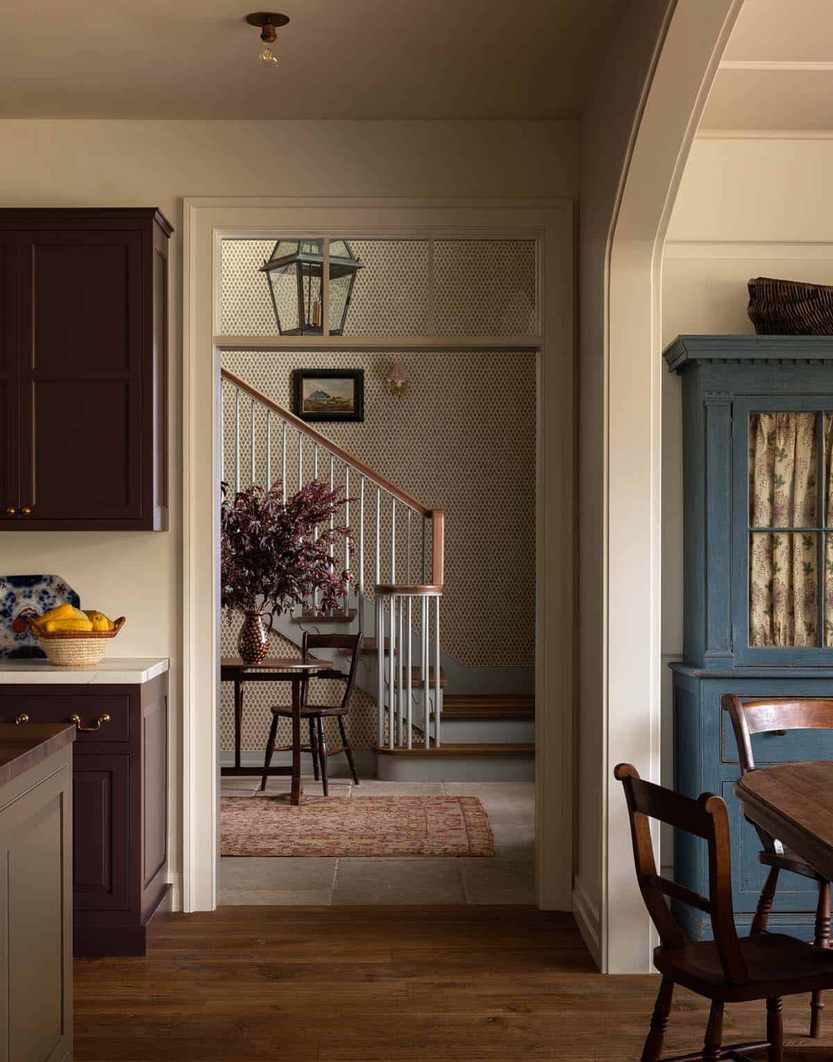 view from kitchen into wallpapered entry hall with staircase, Colorado equestrian home