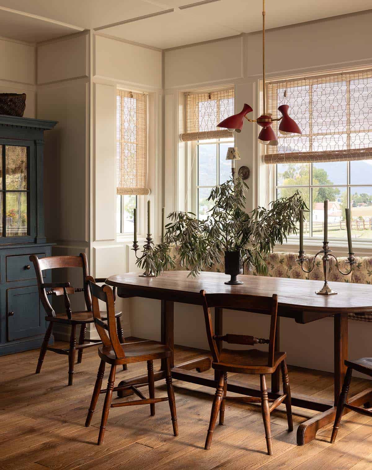 dining area with antique wood table and blue painted hutch, Colorado equestrian home