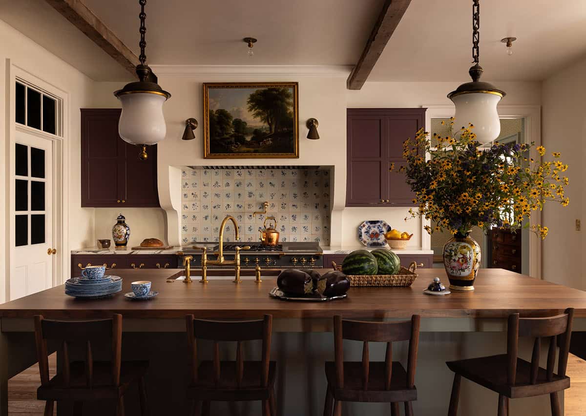 kitchen with plum cabinetry, Delft tile backsplash, and walnut island, Colorado equestrian home