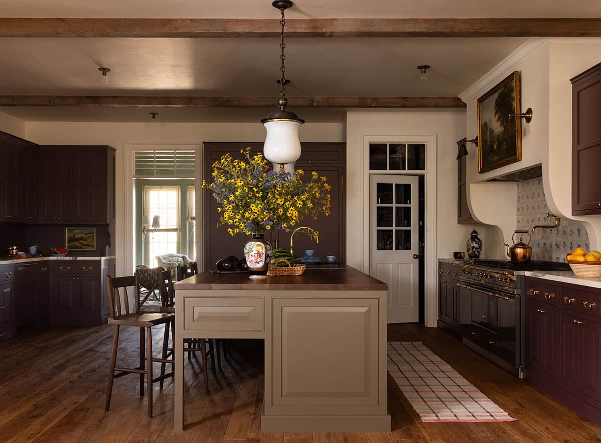 kitchen with exposed wood beams, plum cabinetry, and taupe island, Colorado equestrian home