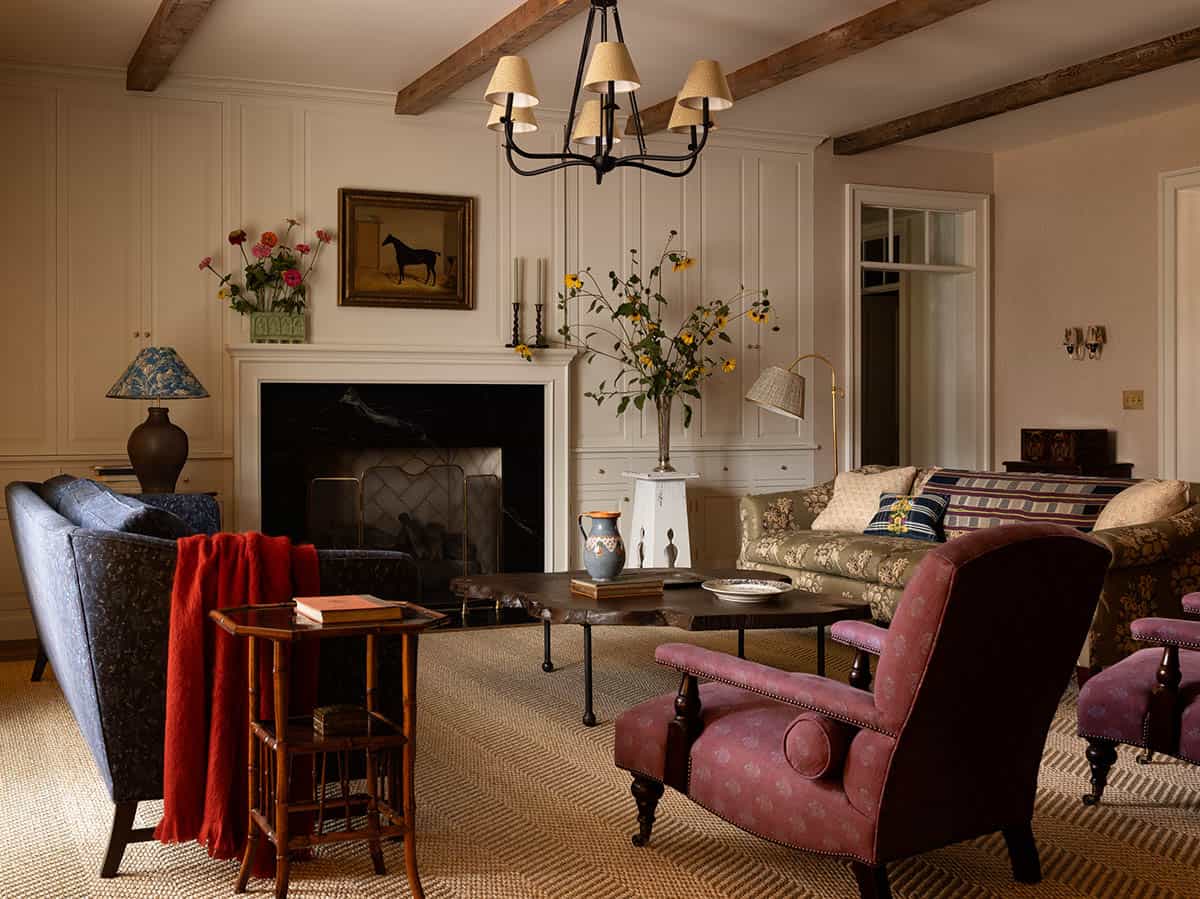 living room with marble fireplace, horse portrait, and layered antique seating, Colorado equestrian home