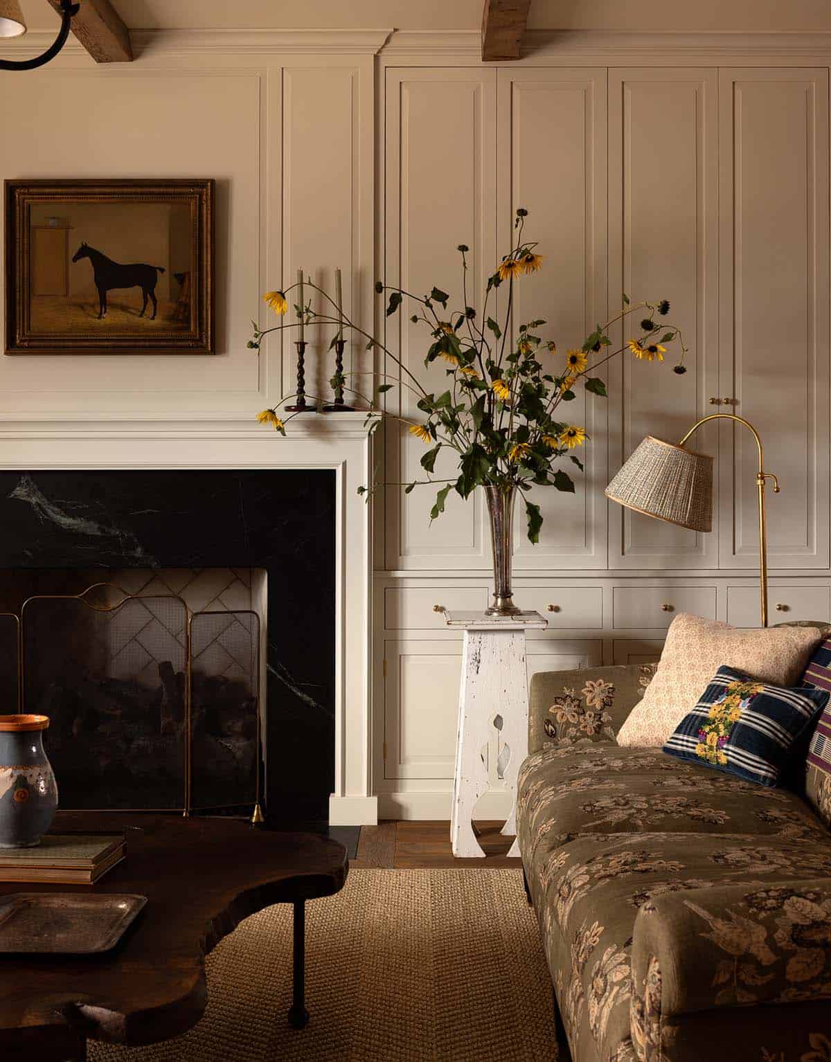 fireplace detail with horse portrait and paneled built-ins, Colorado equestrian home