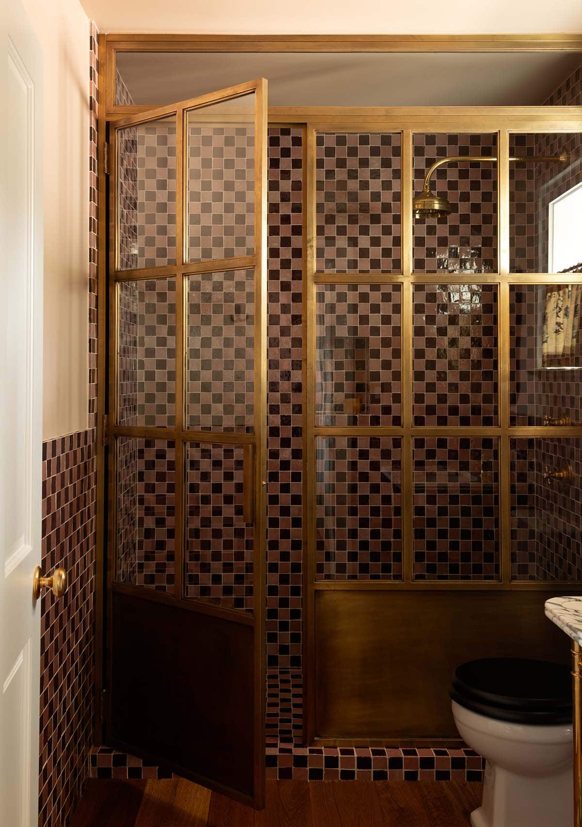 bathroom with checkered tile and brass framed glass shower enclosure, Colorado equestrian home