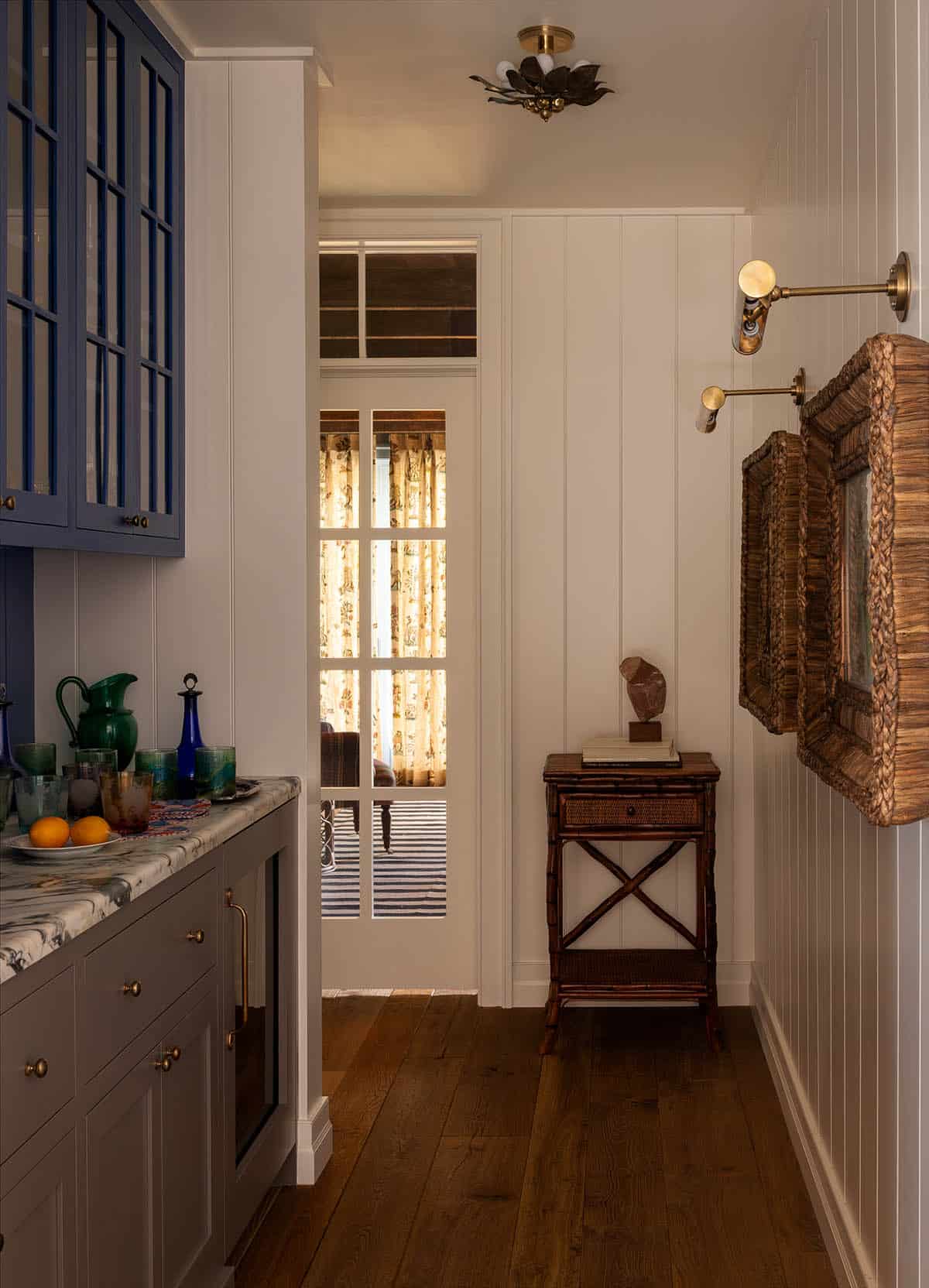 butler's pantry with navy glass front cabinets and marble countertop, Colorado equestrian home