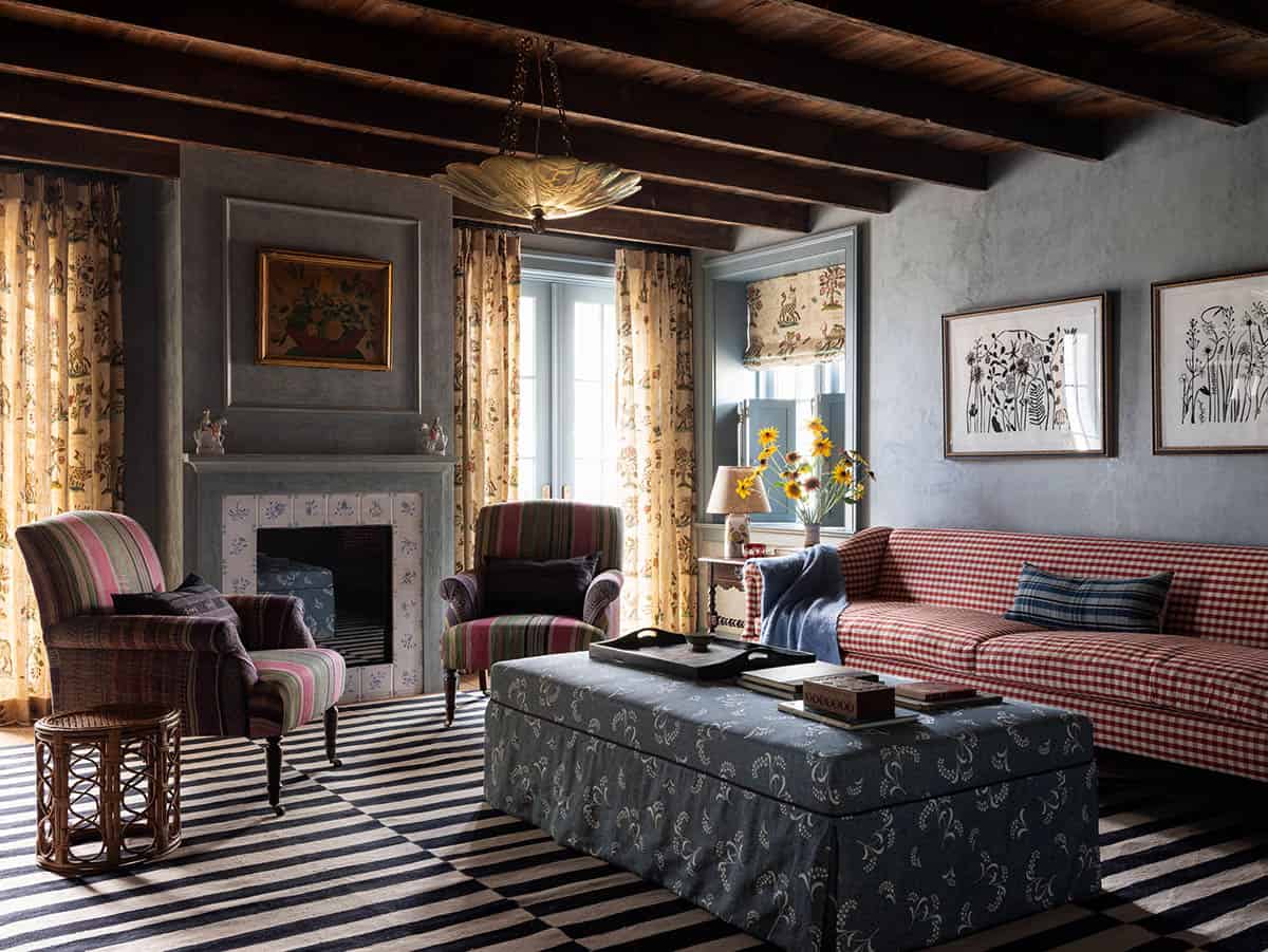 blue plastered family room with gingham sofa, striped rug, and tiled fireplace, Colorado equestrian home