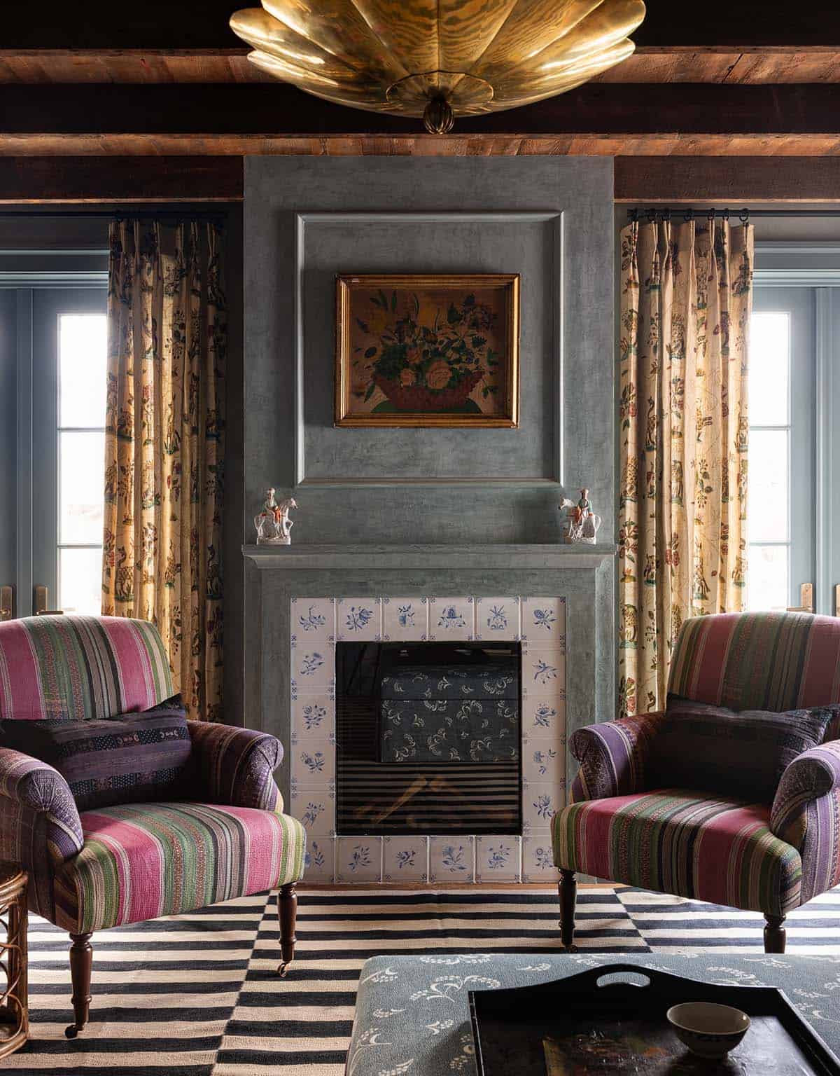 family room fireplace with Delft tile surround and striped armchairs, Colorado equestrian home