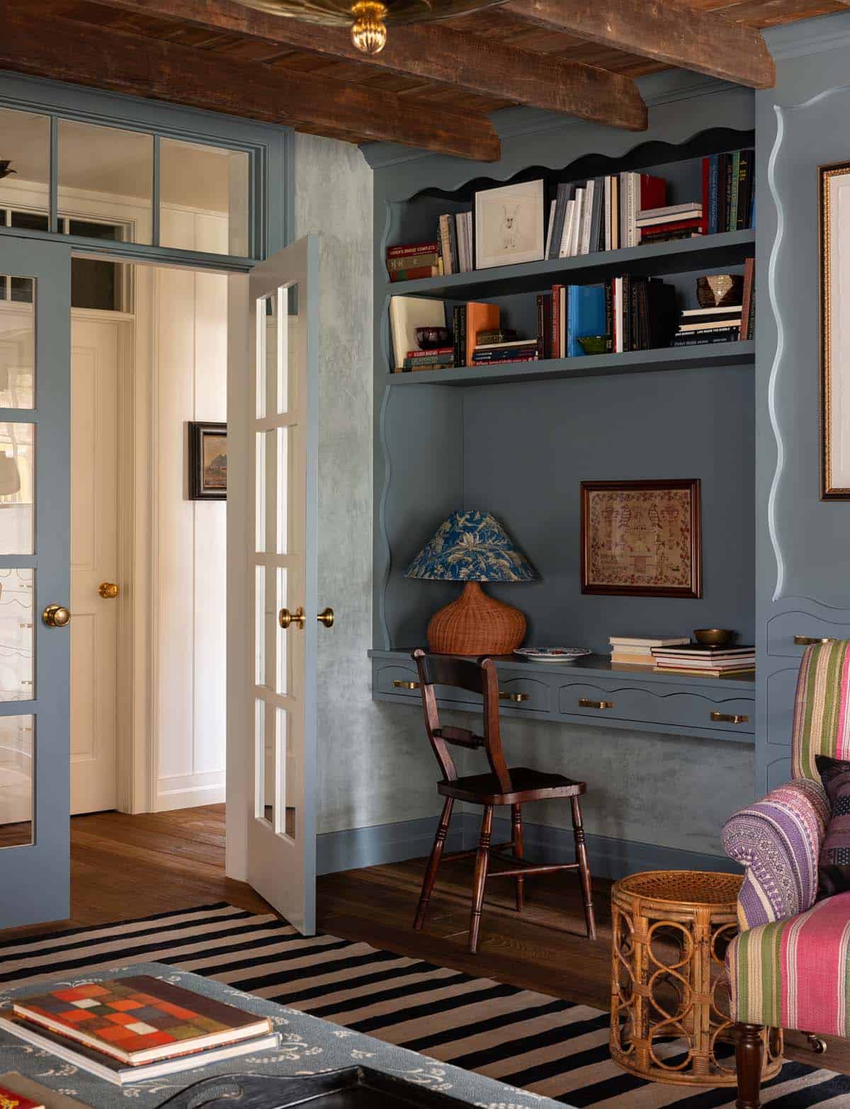 blue family room with built-in desk, bookshelves, and French doors, Colorado equestrian home