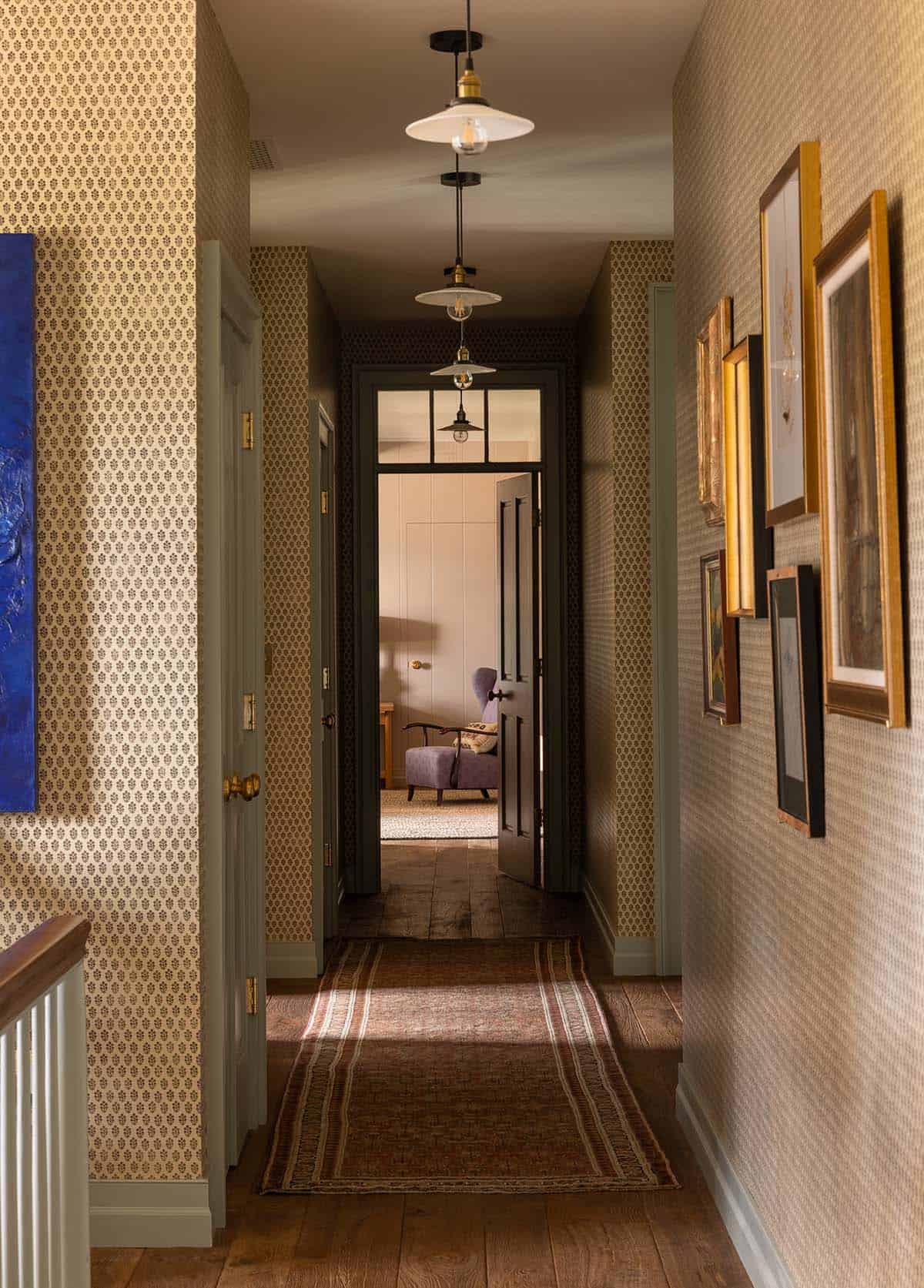 upper hallway with block print wallpaper, pendant lights, and antique art gallery, Colorado equestrian home
