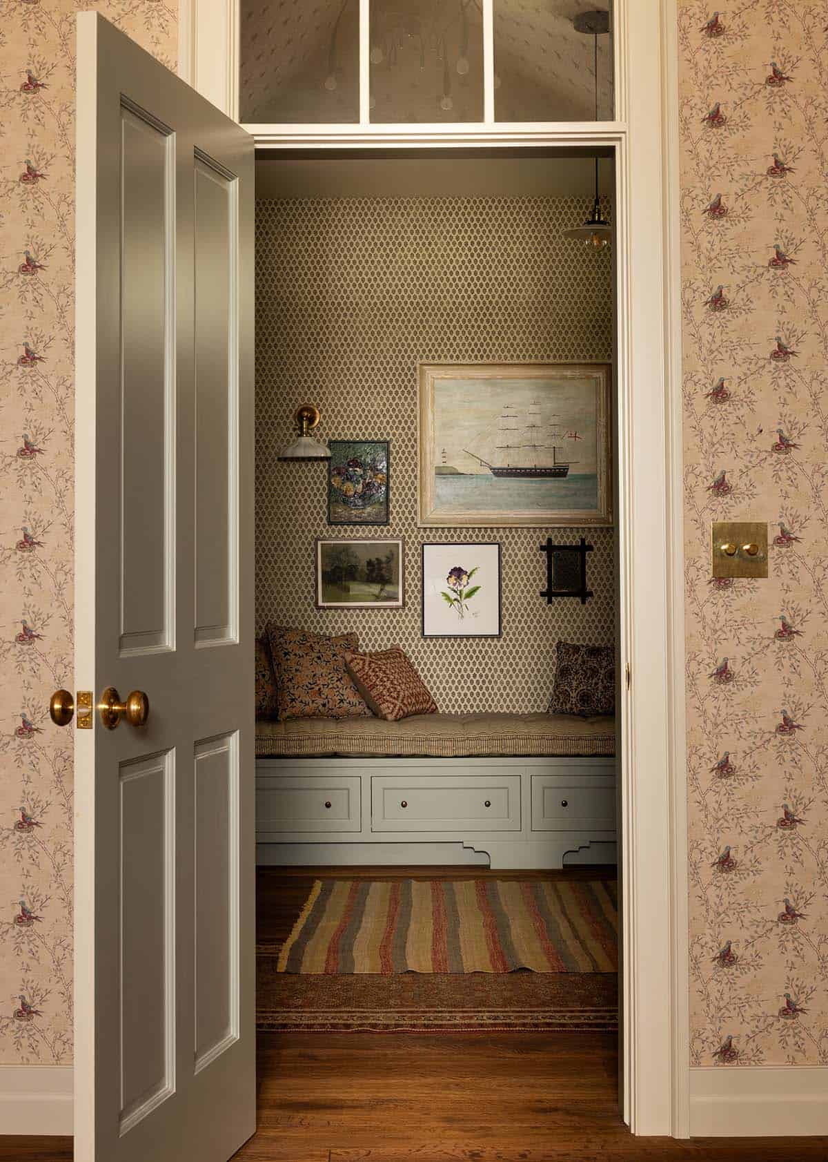 view through doorway into wallpapered reading nook with built-in bench, Colorado equestrian home