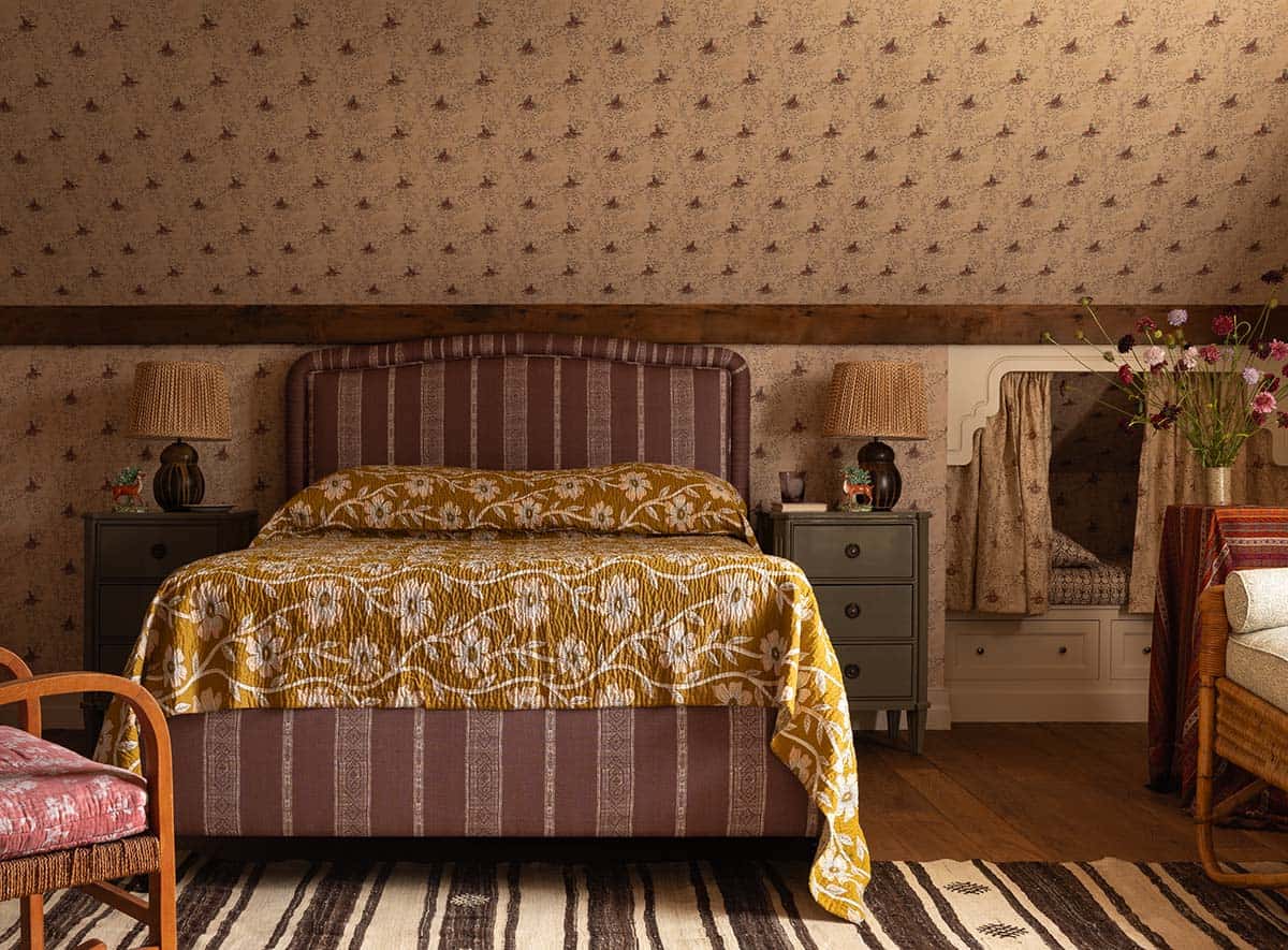 attic guest bedroom with striped upholstered bed and floral quilt, Colorado equestrian home