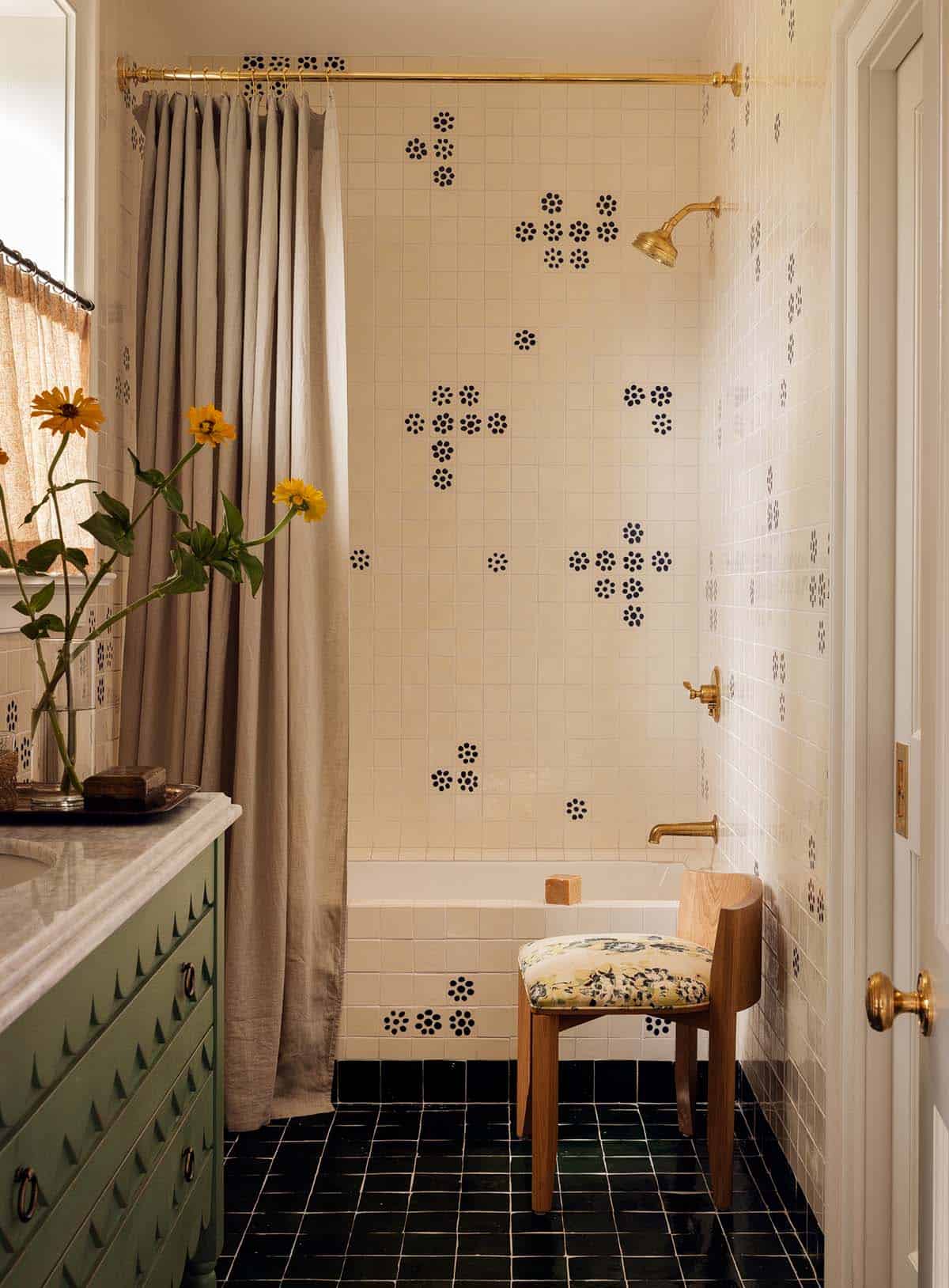 bathroom with patterned tile tub surround, brass fittings, and green vanity, Colorado equestrian home