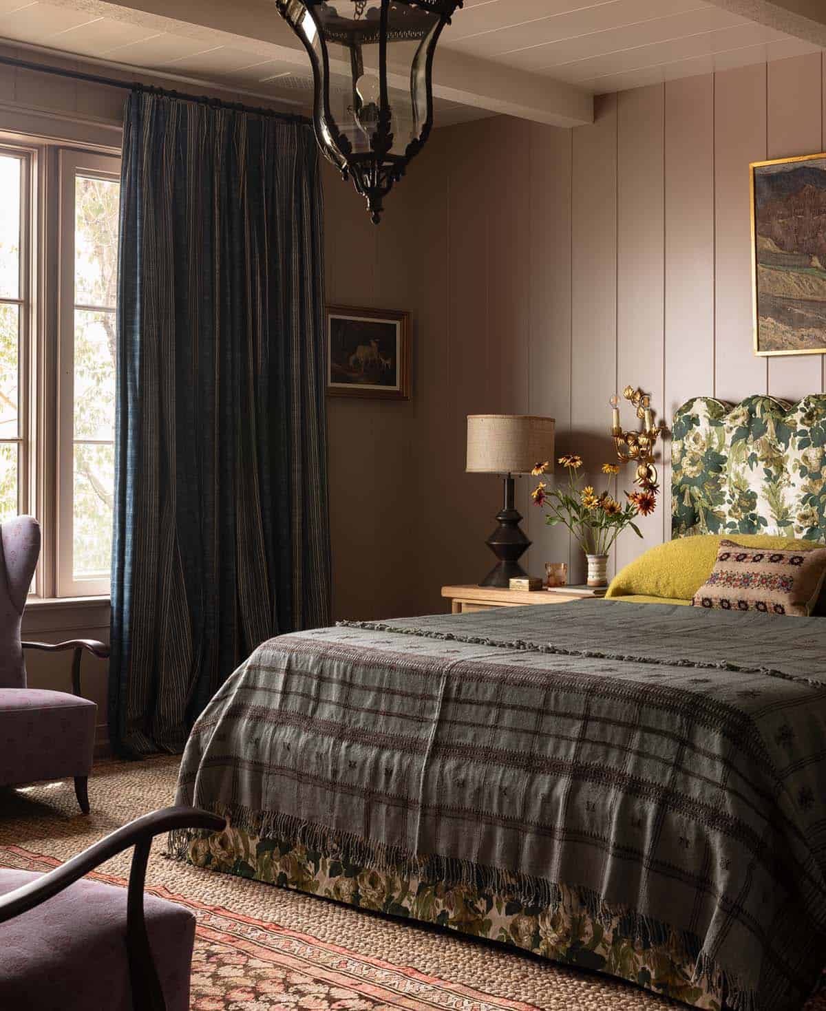 primary bedroom detail with floral headboard and dark velvet drapes, Colorado equestrian home