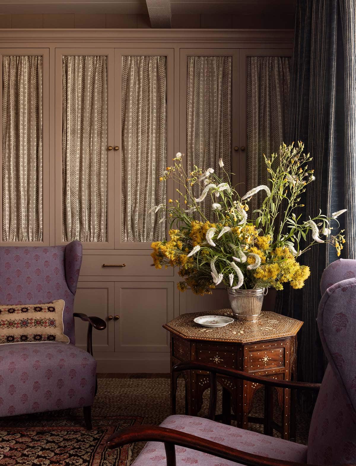 primary bedroom sitting area with built-in wardrobes and inlaid antique side table, Colorado equestrian home