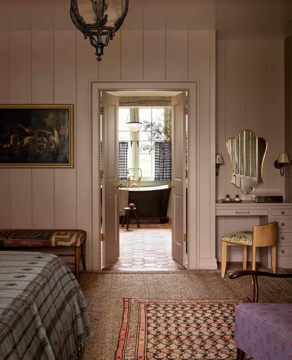 primary bedroom view through to bathroom with black freestanding tub, Colorado equestrian home