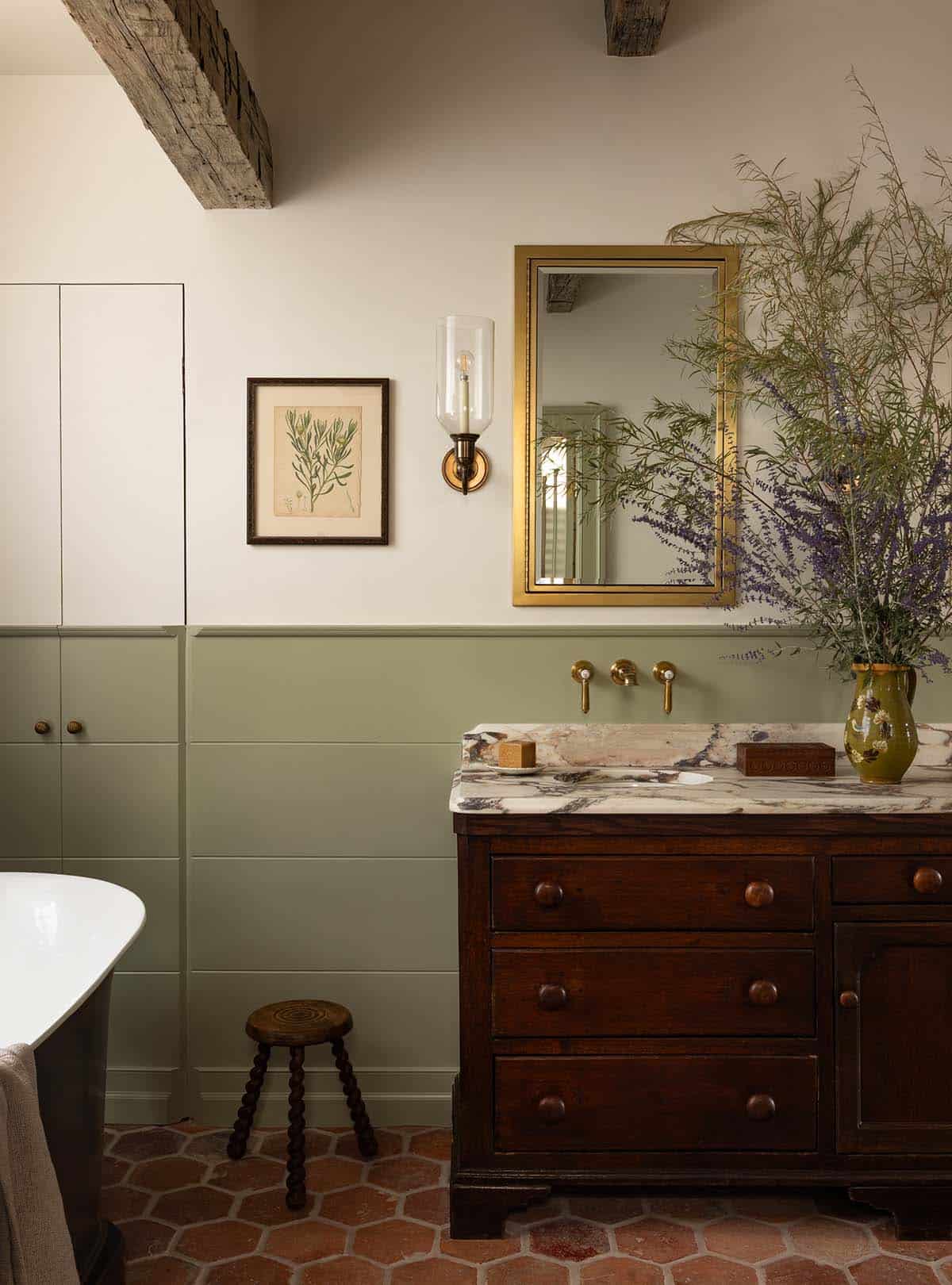 primary bathroom vanity detail with antique chest, marble countertop, and brass mirror, Colorado equestrian home