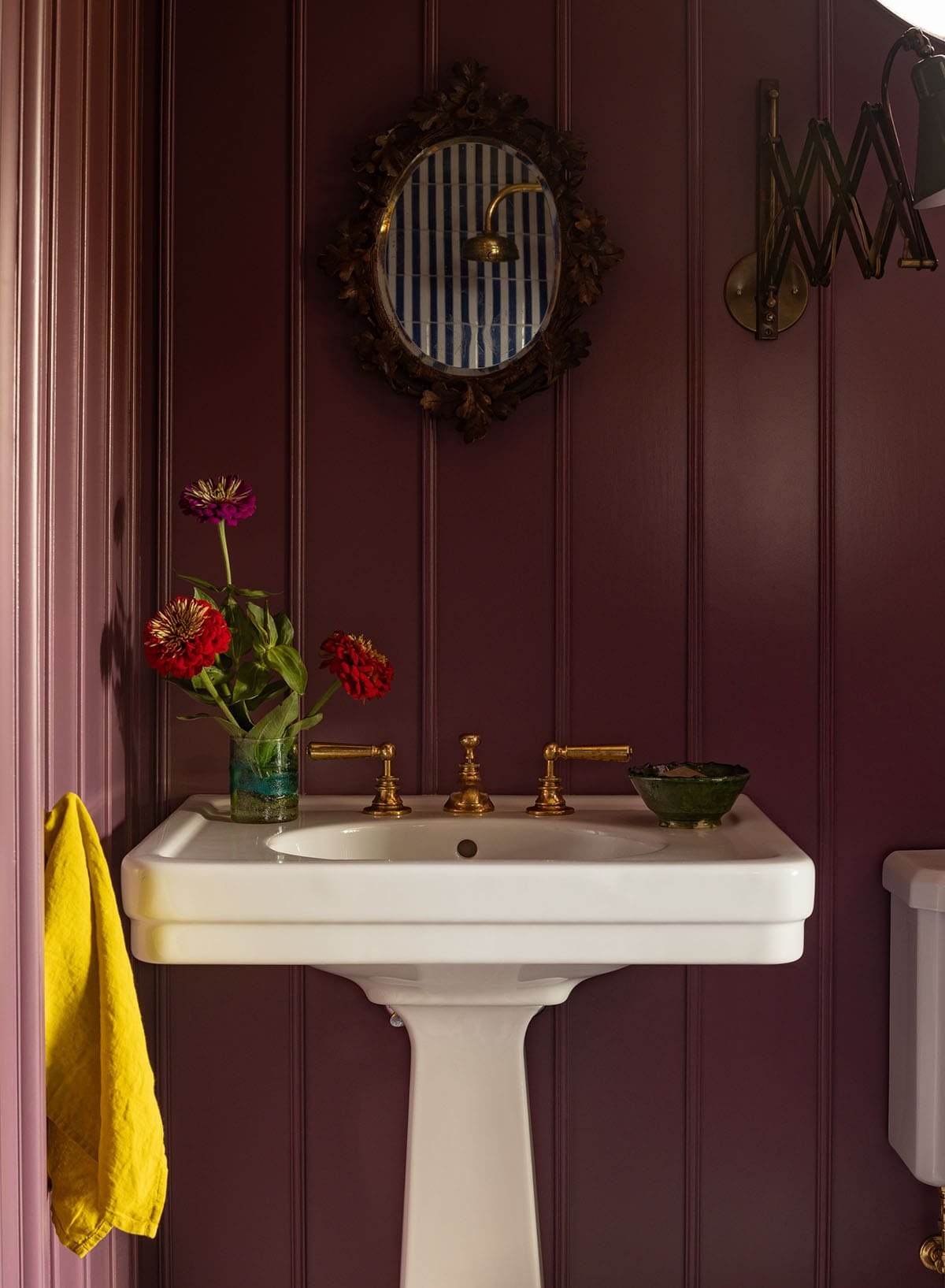 dark plum bathroom sink detail with ornate mirror and brass fittings, Colorado equestrian home