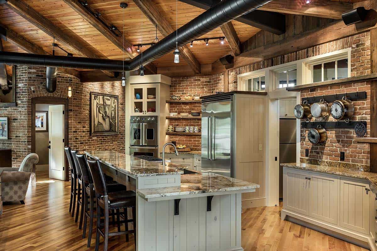 Open concept kitchen with NYC reclaimed brick walls, exposed timber beams, granite island, and Viking appliances
