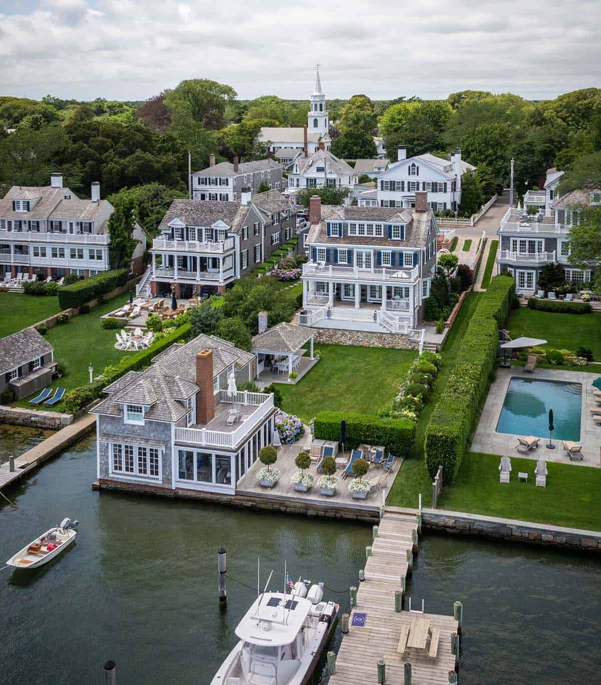 Aerial view of colonial revival waterfront homes with private docks in Massachusetts