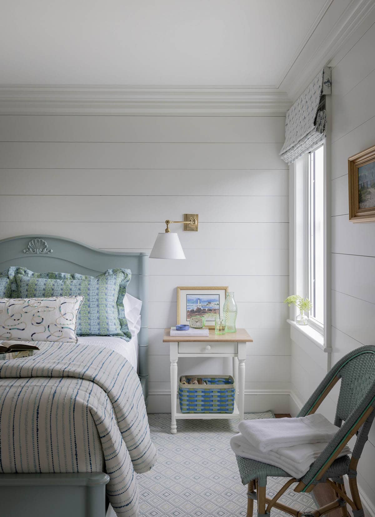 Coastal guest bedroom with seafoam painted bed, shiplap walls and striped quilt