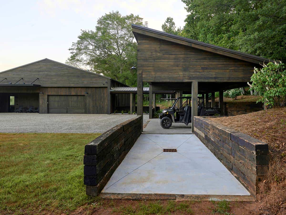 Close-up of concrete ramp with railroad tie retaining walls leading to open carport
