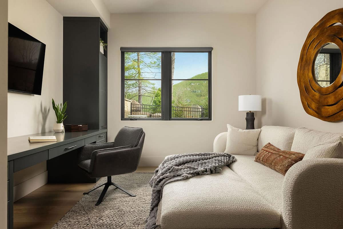 bedroom, sitting area, built-in desk, dark green cabinetry, boucle chaise, mountain view