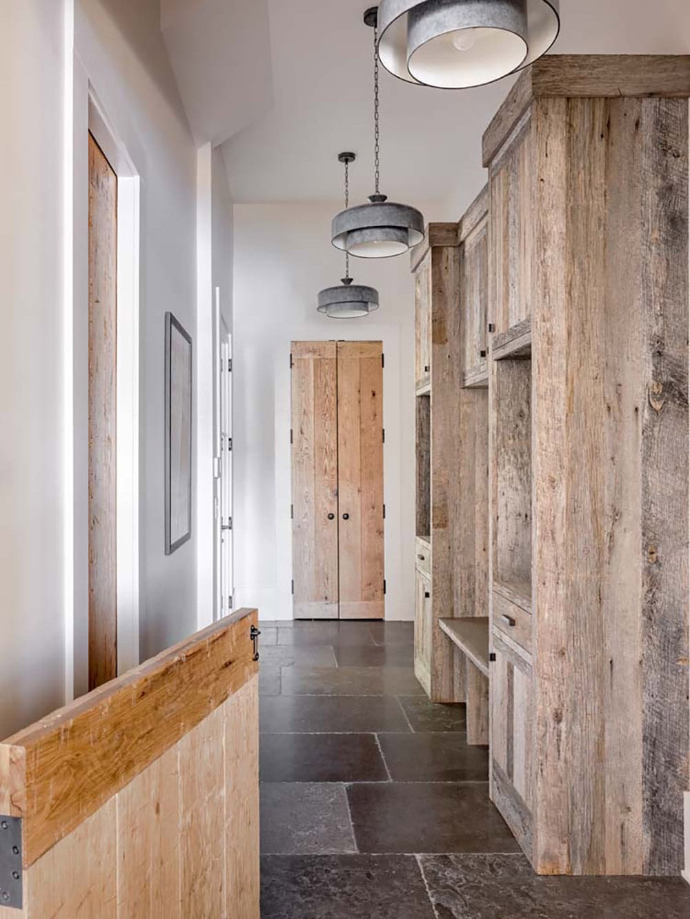 Mudroom hallway with reclaimed wood built-ins and galvanized pendant lights