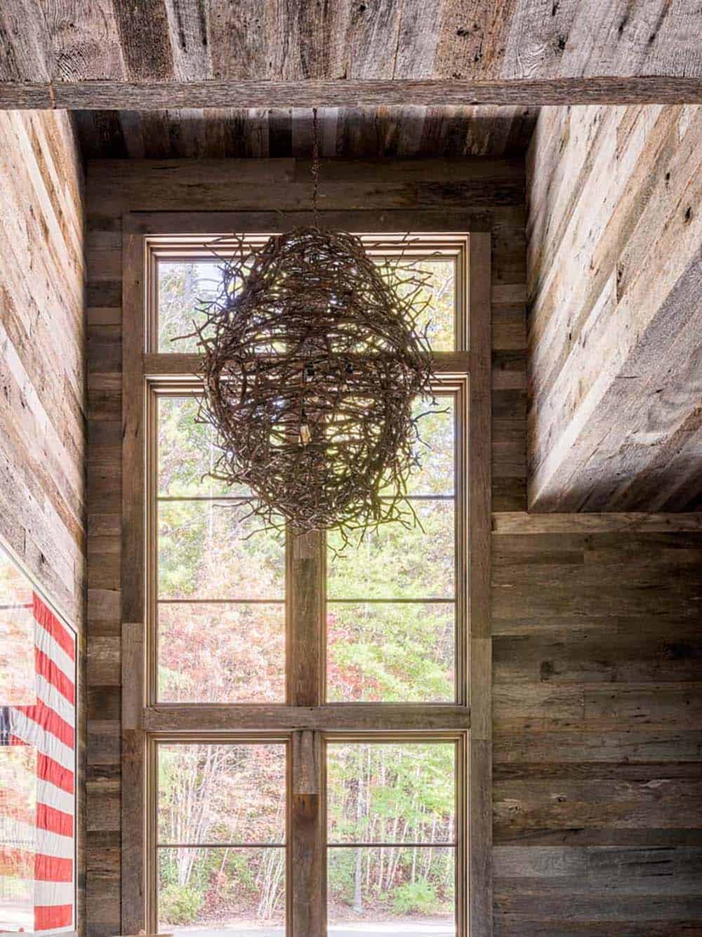 Rustic interior with reclaimed wood walls and twig-ball chandelier